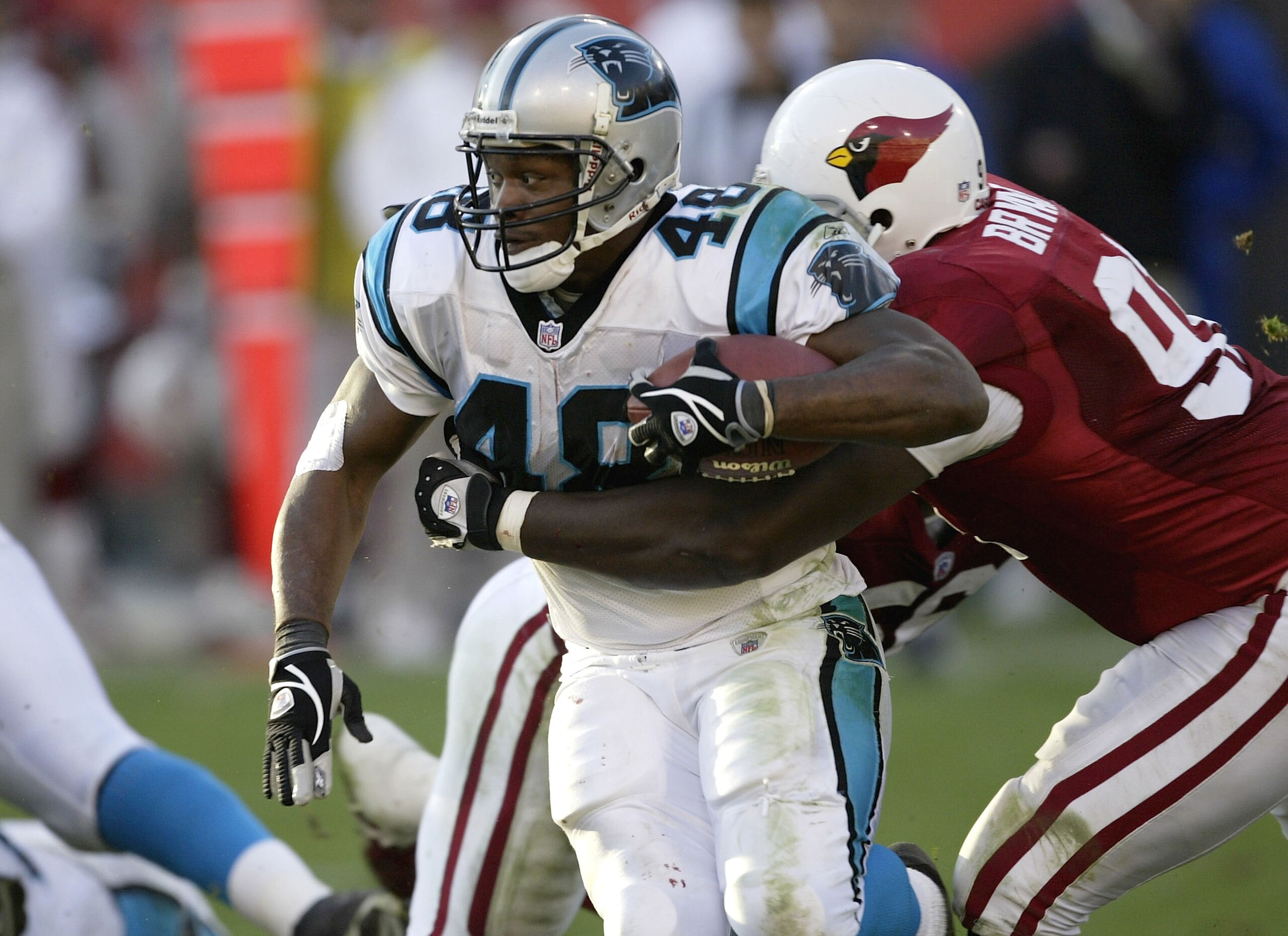 PHOENIX, AZ - DECEMBER 14:  Running back Stephen Davis #46 of the Carolina Panthers fights for yardage while being grabbed by defensive tackle Wendell Bryant # 91 of the Arizona Cardinals on December 14, 2003 at Sun Devil Stadium in Phoenix, Arizona. Caro