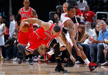 ATLANTA, GA - MAY 06:  Derrick Rose #1 of the Chicago Bulls protecs the ball from Jeff Teague #0 of the Atlanta Hawks in Game Three of the Eastern Conference Semifinals in the 2011 NBA Playoffs at Phillips Arena on May 6, 2011 in Atlanta, Georgia.  NOTE T
