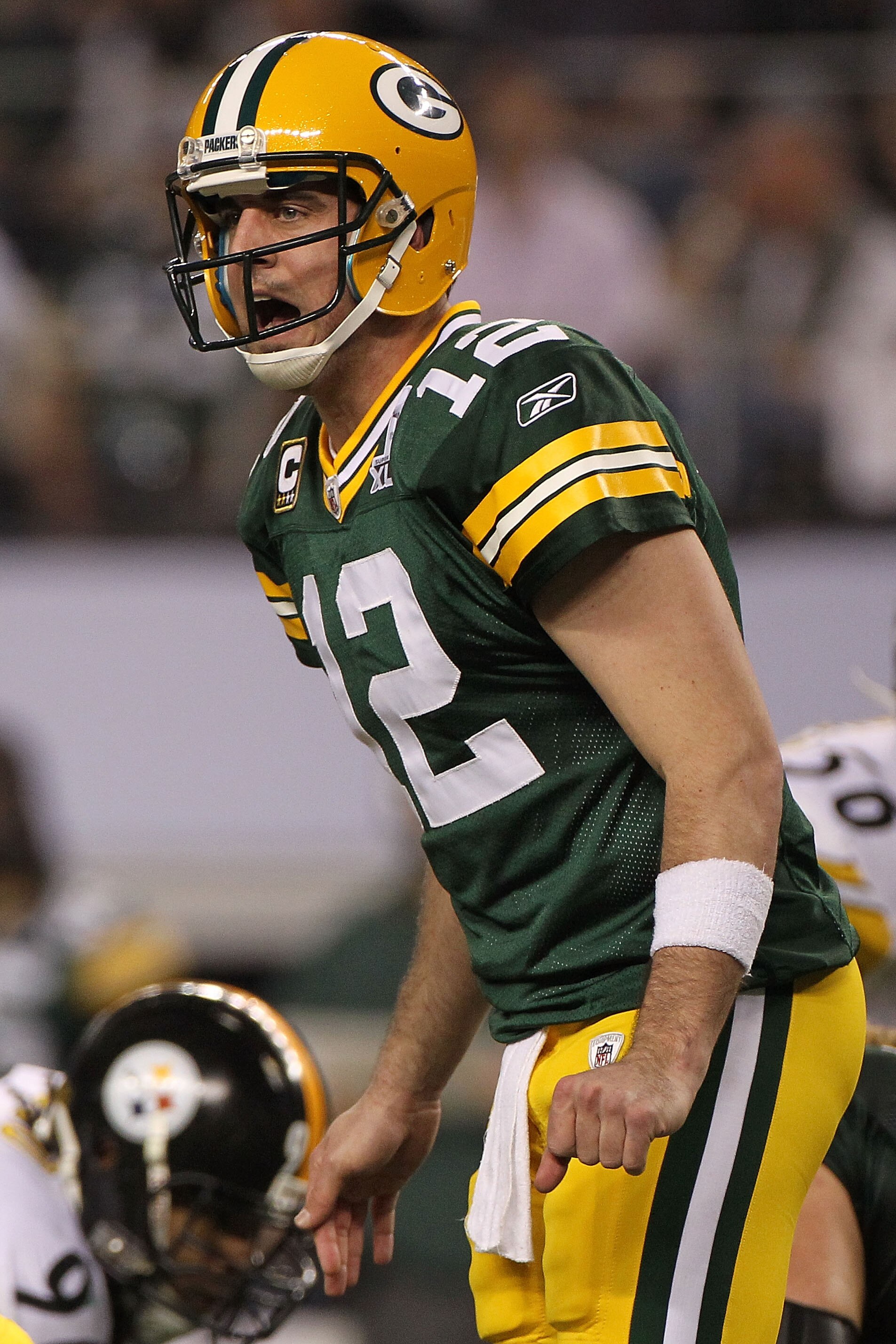 ARLINGTON, TX - FEBRUARY 06:  Quarterback Aaron Rodgers #12 of the Green Bay Packers calls out from under center while taking on the Pittsburgh Steelers during Super Bowl XLV at Cowboys Stadium on February 6, 2011 in Arlington, Texas.  (Photo by Doug Pens
