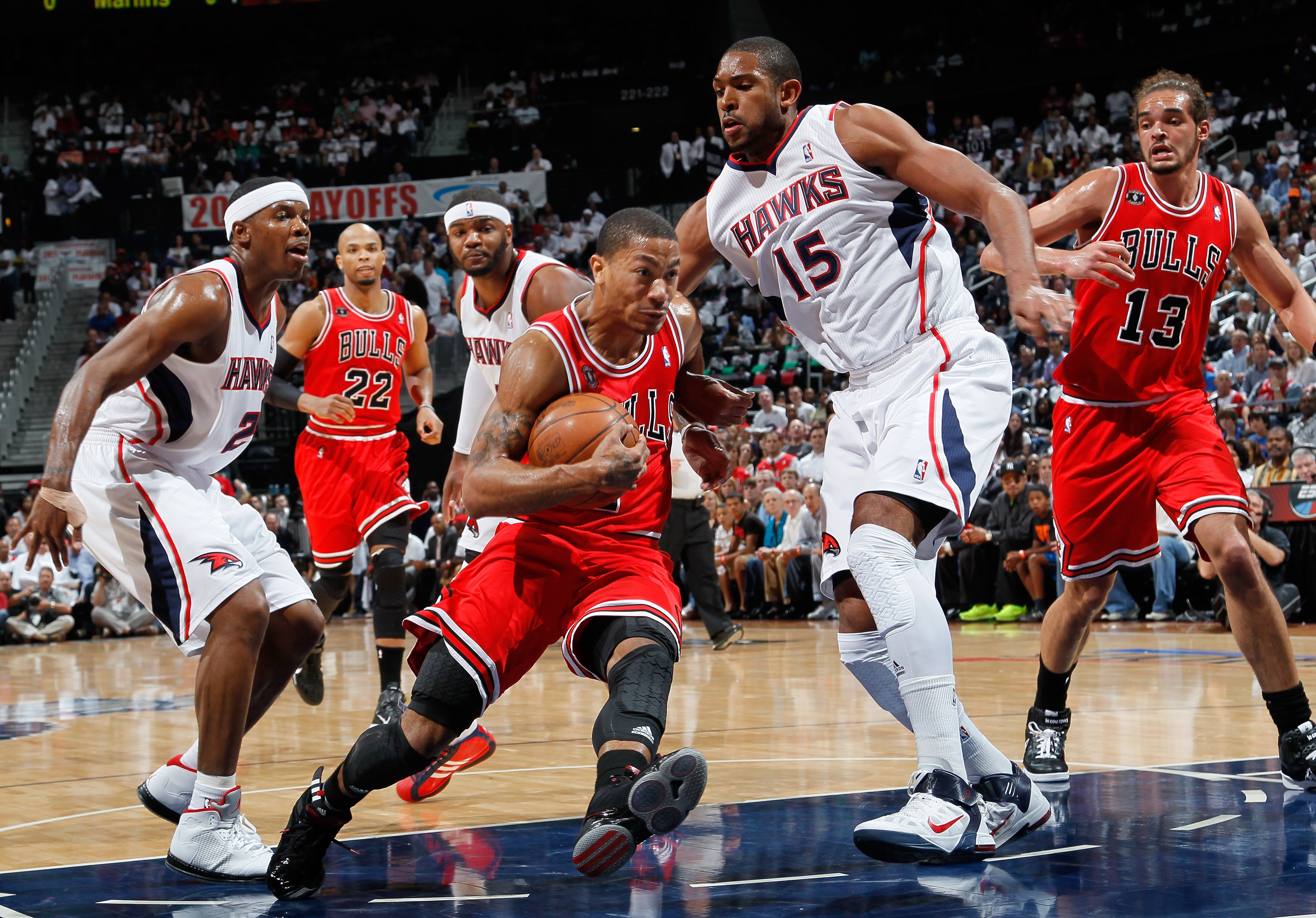 ATLANTA, GA - MAY 06:  Derrick Rose #1 of the Chicago Bulls drives against Joe Johnson #2 and Al Horford #15 of the Atlanta Hawks in Game Three of the Eastern Conference Semifinals in the 2011 NBA Playoffs at Phillips Arena on May 6, 2011 in Atlanta, Geor