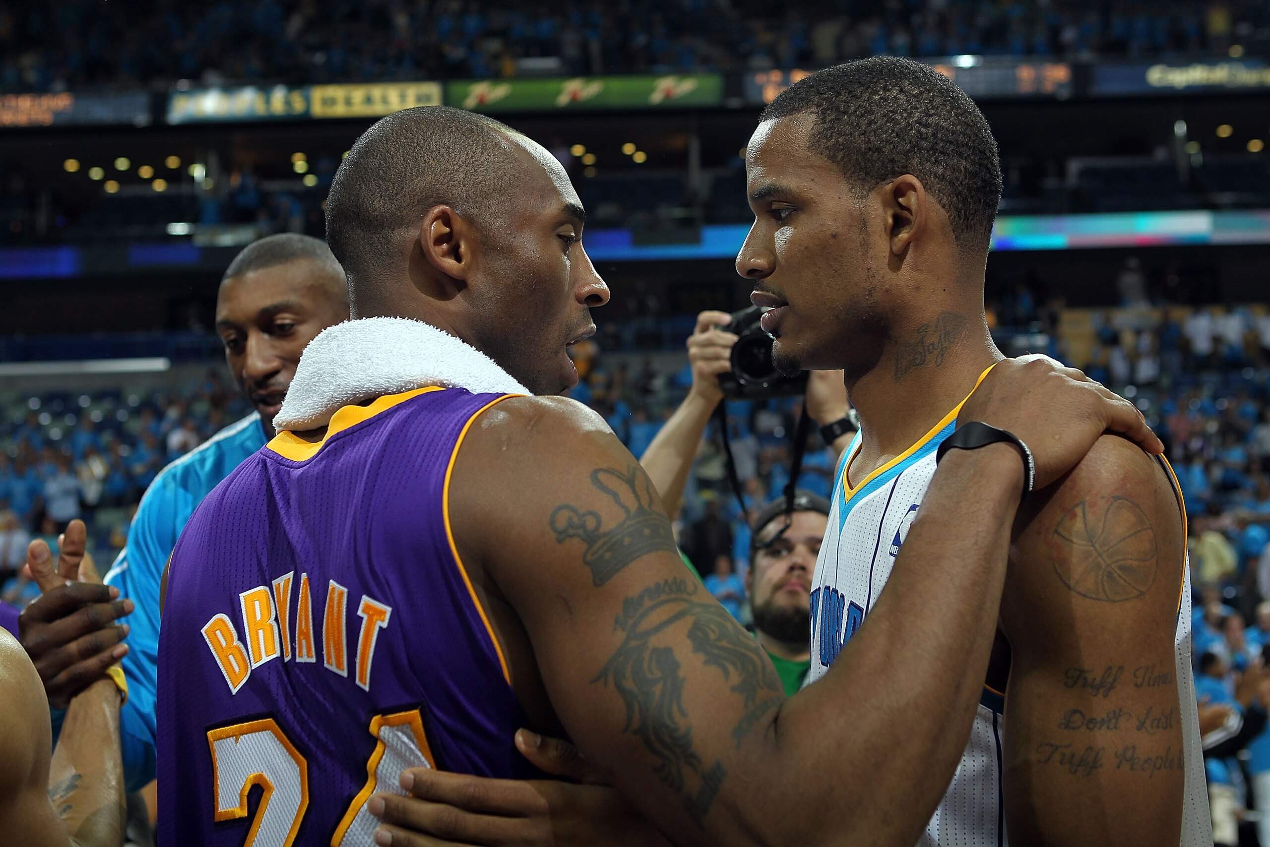 NEW ORLEANS, LA - APRIL 28:  Trevor Ariza #1 of the New Orleans Hornets hugs Kobe Bryant #24 of the Los Angeles Lakers after the Lakers won the series in Game Six of the Western Conference Quarterfinals in the 2011 NBA Playoffs on April 28, 2011 at New Or