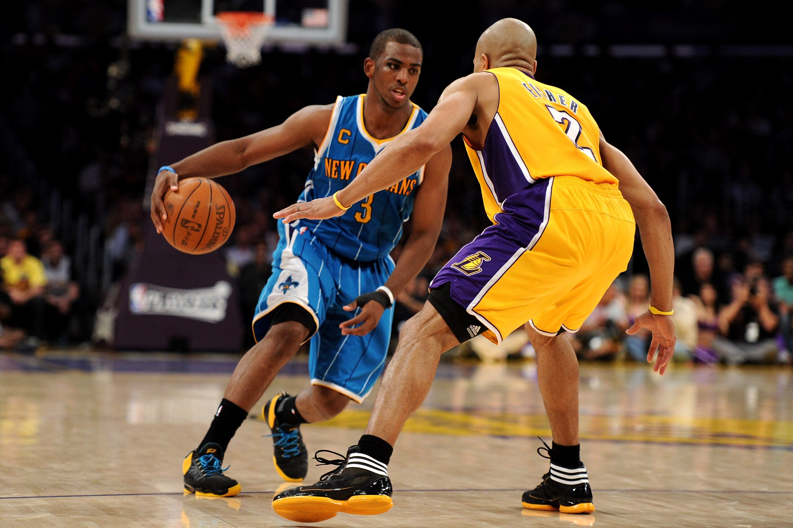LOS ANGELES, CA - APRIL 26:  Chris Paul #3 of the New Orleans Hornets drives on Derek Fisher #2 of the Los Angeles Lakers in Game Five of the Western Conference Quarterfinals in the 2011 NBA Playoffs on April 26, 2011 at Staples Center in Los Angeles, Cal