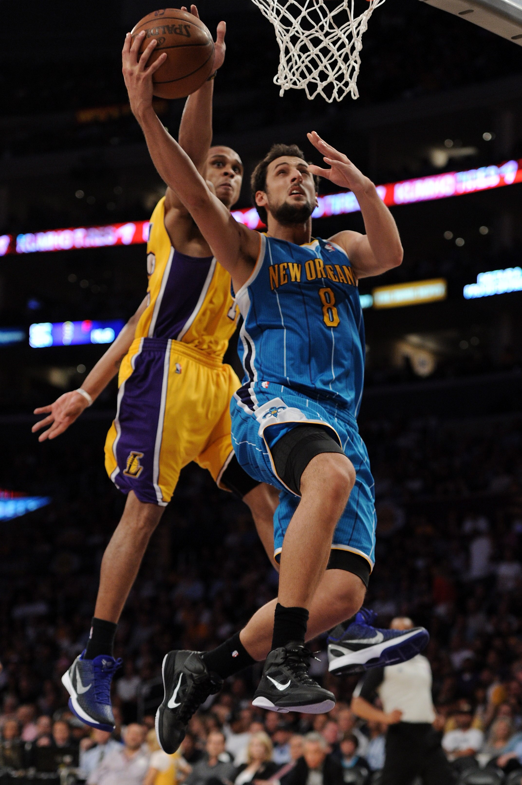 LOS ANGELES, CA - APRIL 26:  Marco Belinelli #8 of the New Orleans Hornets goes up for a layup in front of Shannon Brown #12 of the Los Angeles Lakers in the second half in Game Five of the Western Conference Quarterfinals in the 2011 NBA Playoffs on Apri