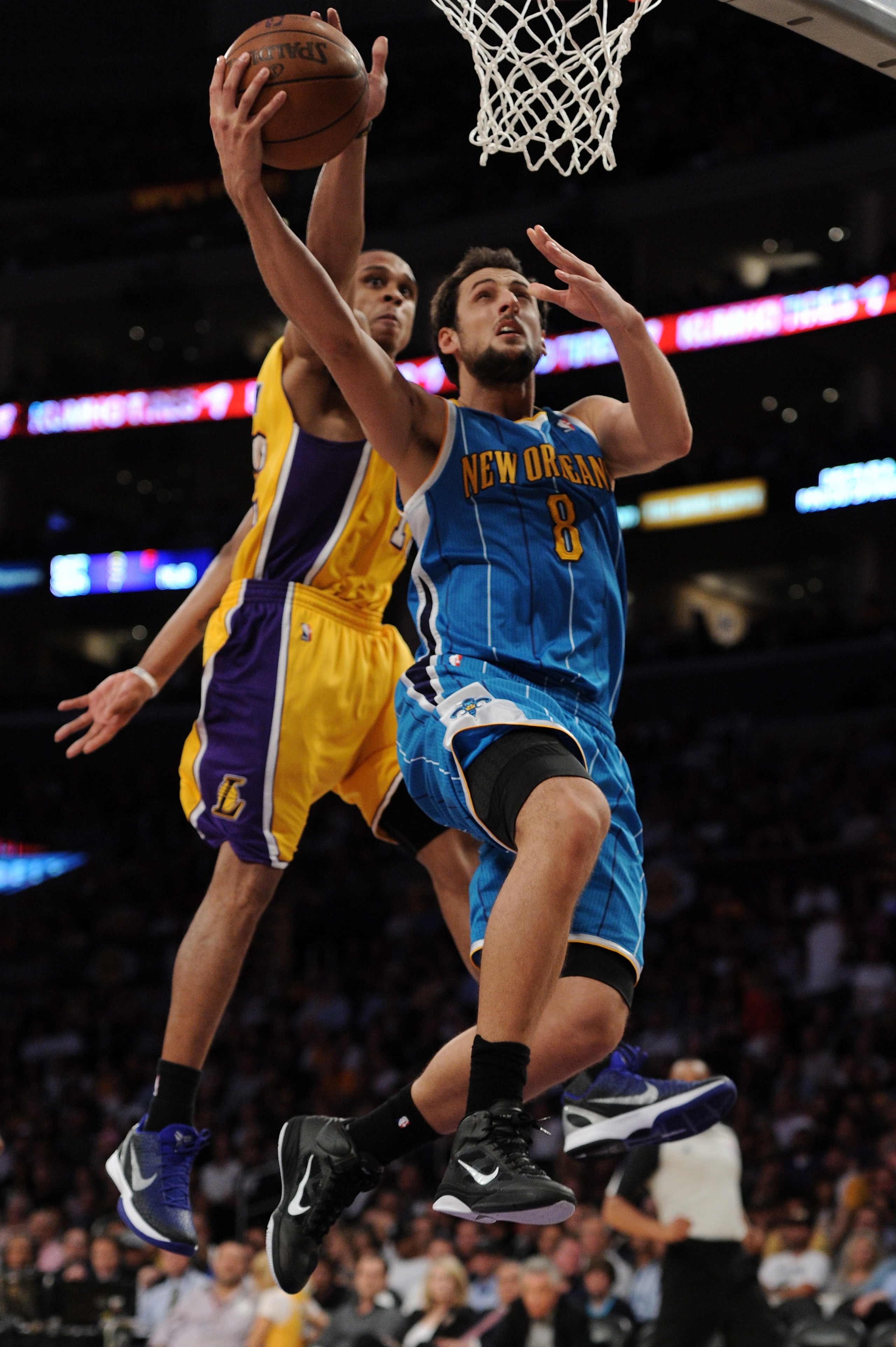 LOS ANGELES, CA - APRIL 26:  Marco Belinelli #8 of the New Orleans Hornets goes up for a layup in front of Shannon Brown #12 of the Los Angeles Lakers in the second half in Game Five of the Western Conference Quarterfinals in the 2011 NBA Playoffs on Apri