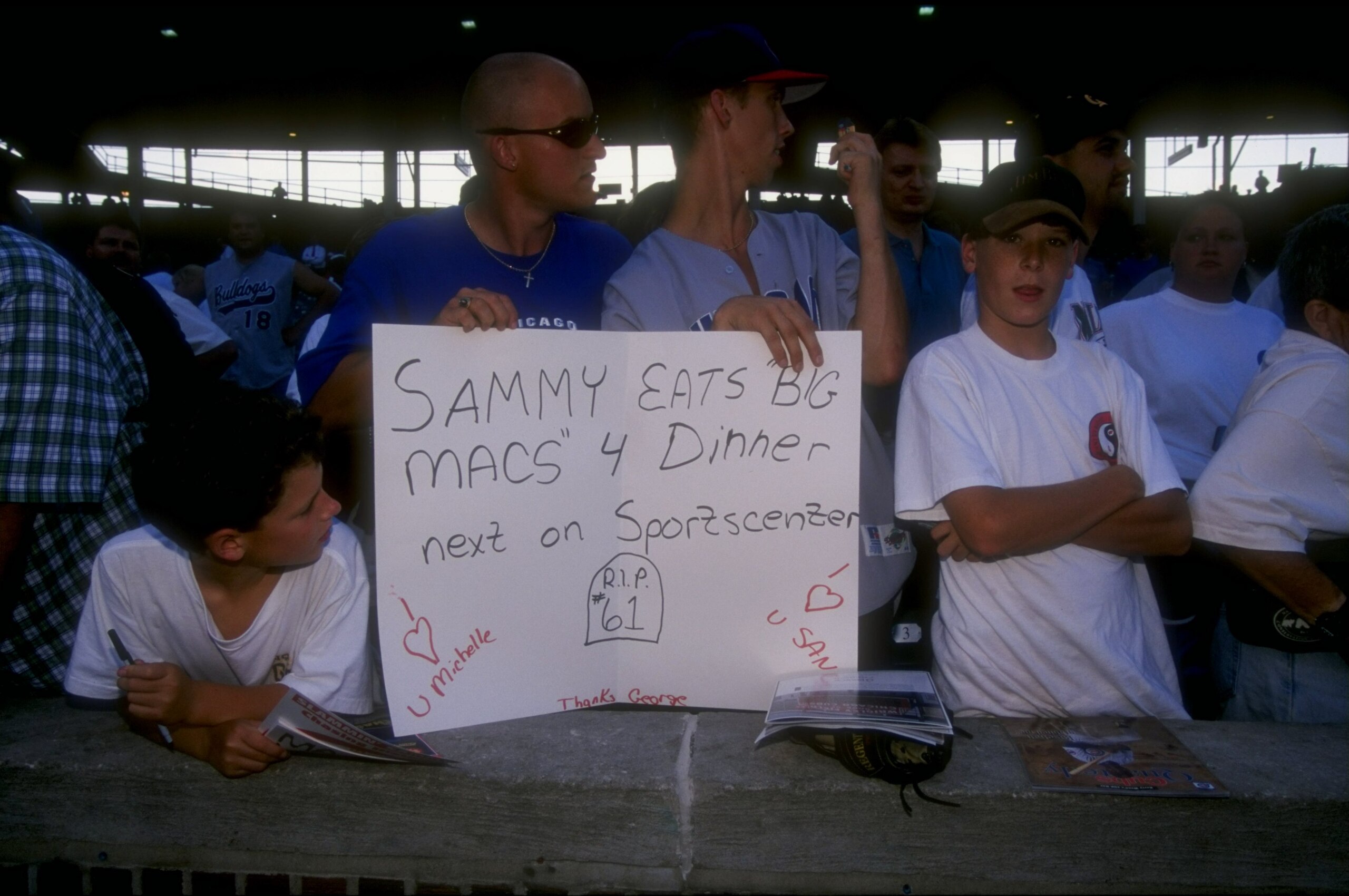 Fans of Sammy Sosa #21 of the Chicago Cubs holding a 'SAMMY EATS BIG MACS'' 4 Dinner next on Sportscenter' sign during the game against the Cincinnati Reds at Wrigley Field in Chicago, Illinois. The Cubs defeated the Reds 6-5.