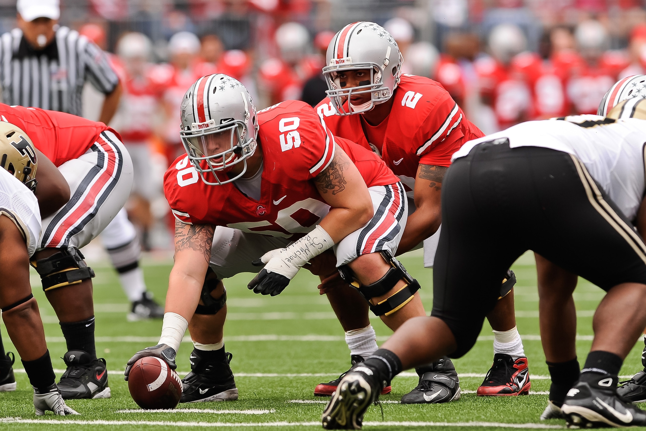 COLUMBUS, OH - OCTOBER 23:  Michael Brewster #50 of the Ohio State Buckeyes prepares to snap the ball to quarterback Terrelle Pryor #2 of the Ohio State Buckeyes against the Purdue Boilermakers at Ohio Stadium on October 23, 2010 in Columbus, Ohio.  (Phot