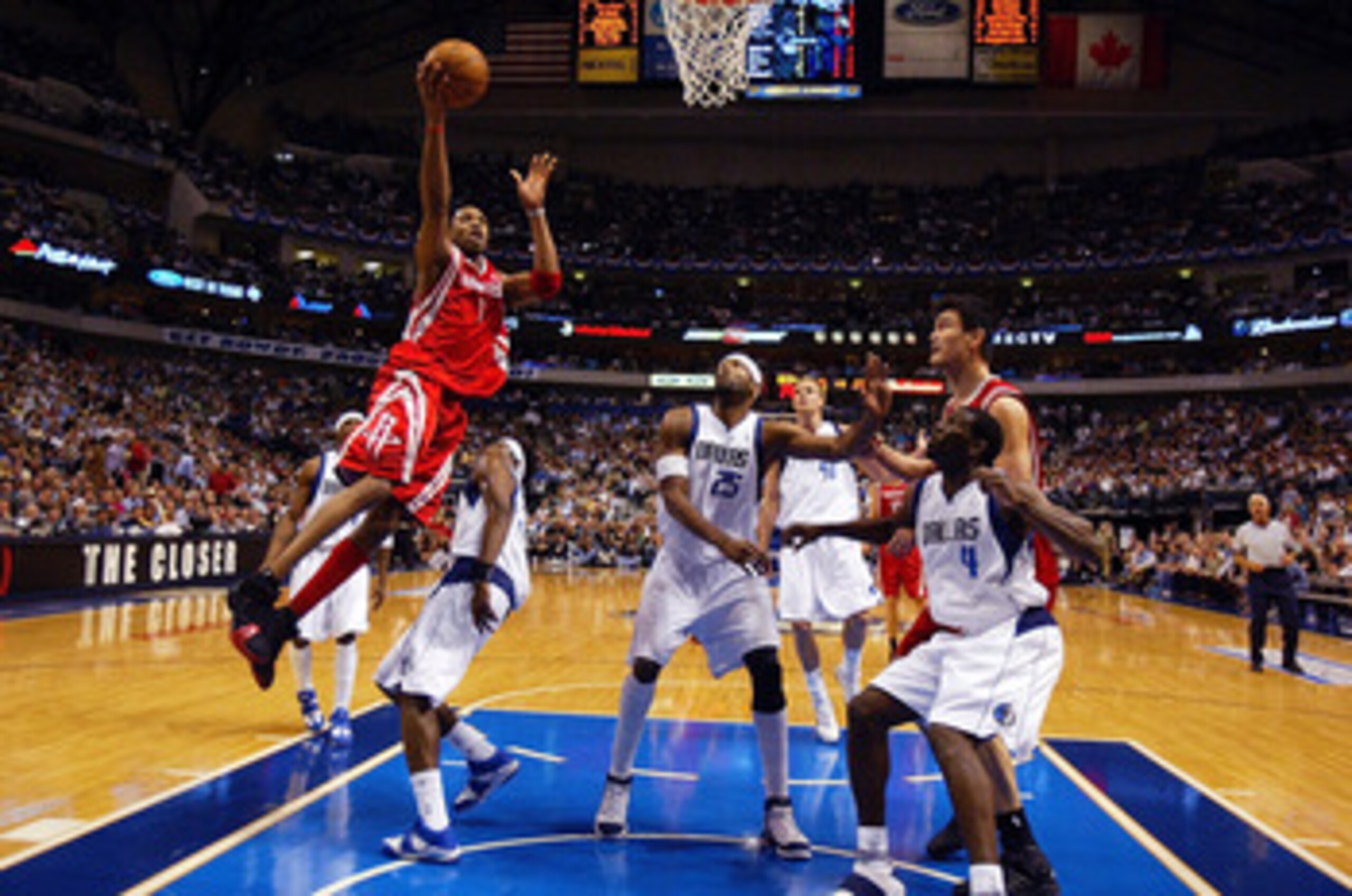 DALLAS - MAY 2:  Tracy McGrady #1 of the Houston Rockets drives to the hoop against Josh Howard #5 of the Dallas Mavericks in Game five of the Western Conference Quarterfinals during the 2005 NBA Playoffs on May 2, 2005 at the American Airlines Center in 