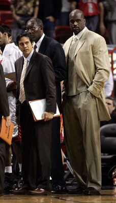 MIAMI - DECEMBER 9:  Center Shaquille O'Neal #32 of the Miami Heat stands on the bench with assistant coaches Erik Spoelstra and Bob McAdoo against the Denver Nuggets in the fourth period on December 9, 2005 at the American Airlines Arena in Miami, Florid