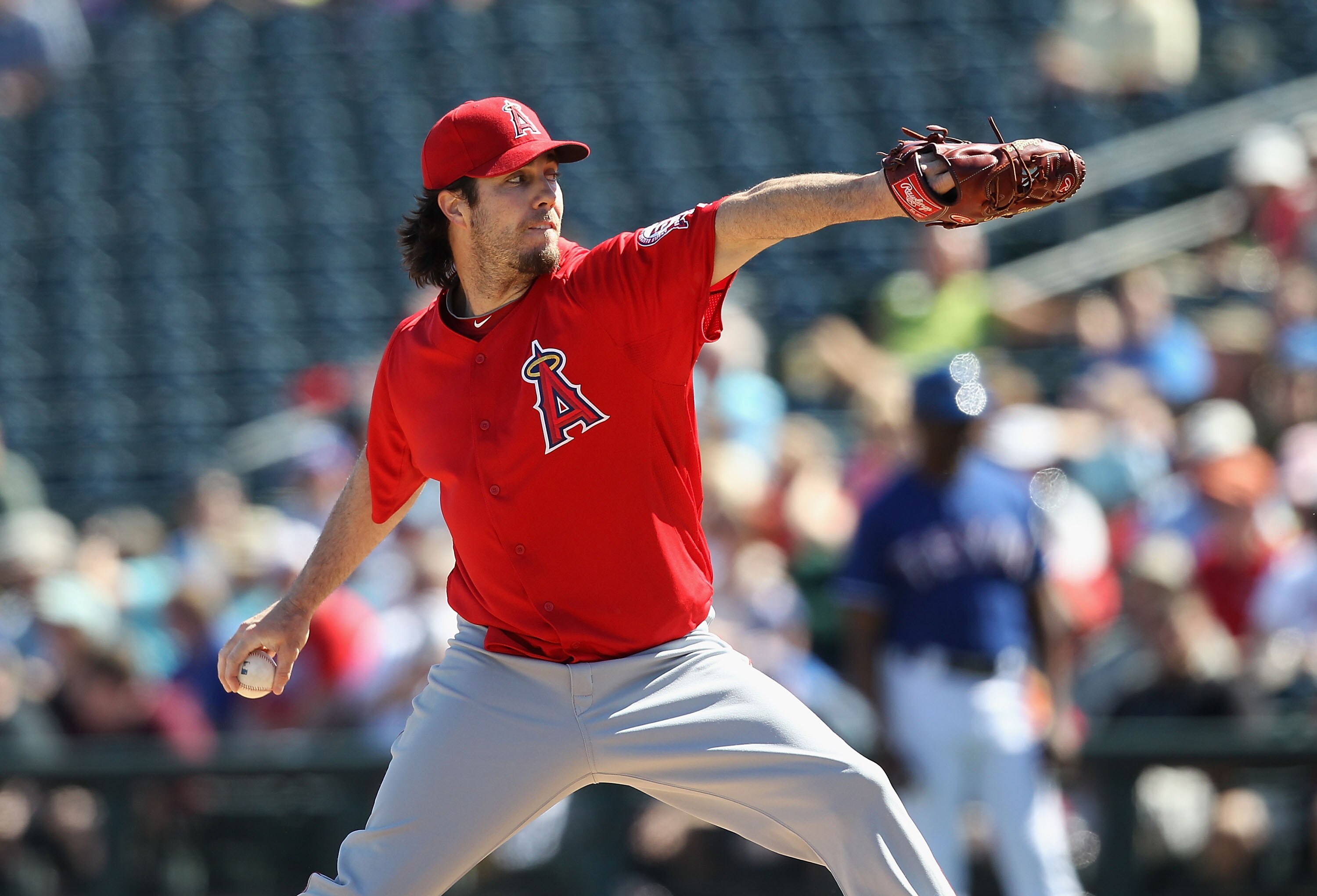 SURPRISE, AZ - MARCH 02:  Starting pitcher Dan Haren #24 of the Los Angeles Angels of Anaheim pitches against the Texas Rangers during the spring training game at Surprise Stadium on March 2, 2011 in Surprise, Arizona.  (Photo by Christian Petersen/Getty