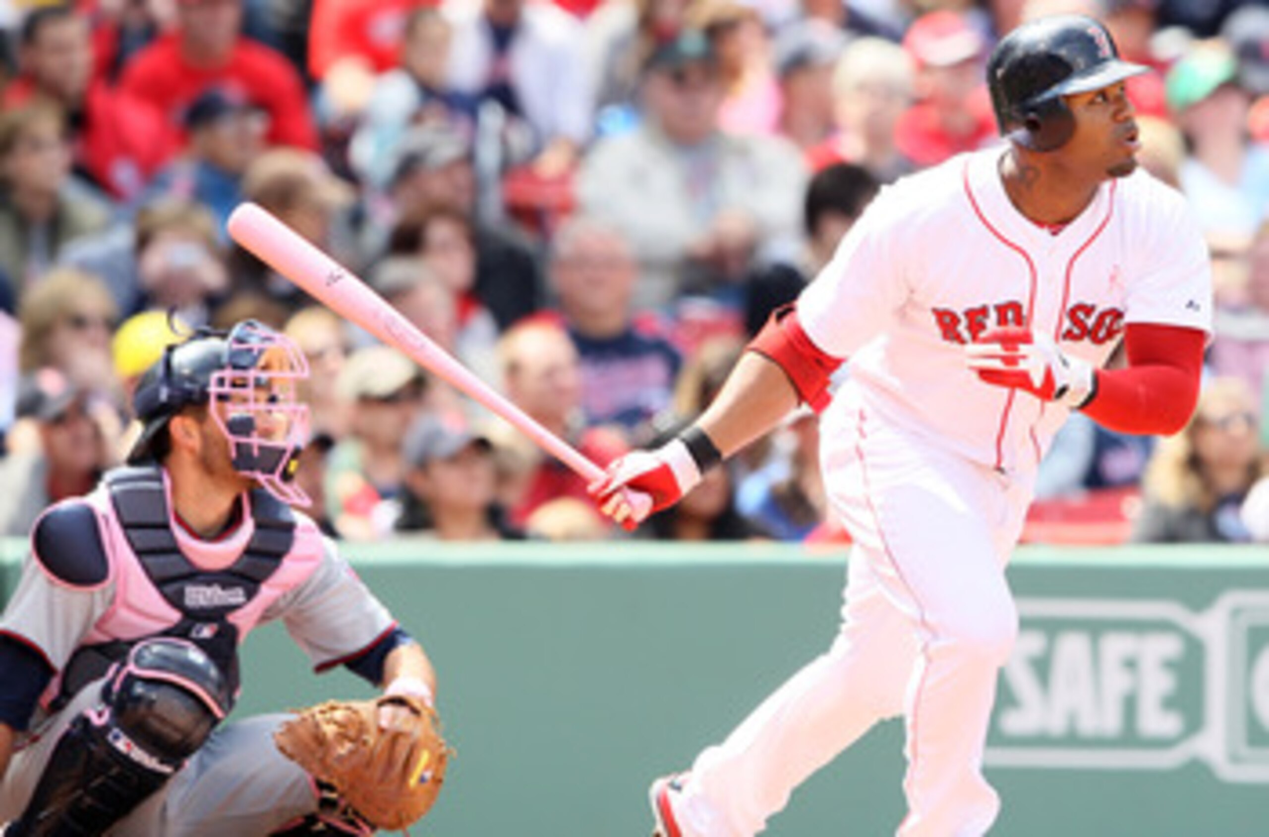 BOSTON, MA - MAY 08:  Carl Crawford #13 of the Boston Red Sox hits a triple as Drew Butera #41 of the Minnesota Twins catches on May 8, 2011 at Fenway Park in Boston, Massachusetts. The Minnesota Twins and the Boston Red Sox wore pink and used pink bats i