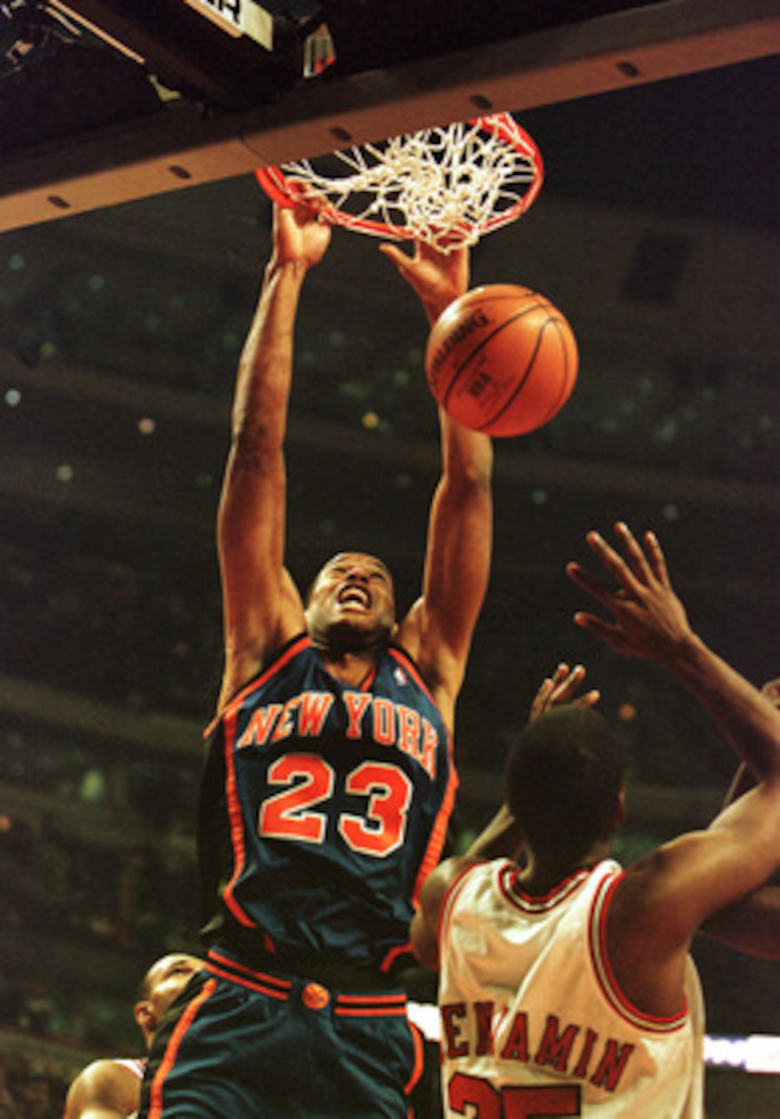 01 Dec 2000: Center Marcus Camby #23 of the New York Knicks slams the ball down while Guard Cory Benjamin #25 of the Chicago Bulls attempts to defend in early action at the United Center in Chicago, Illinois. Mandatory Credit: Jonathan Daniel/ALLSPORT  NO