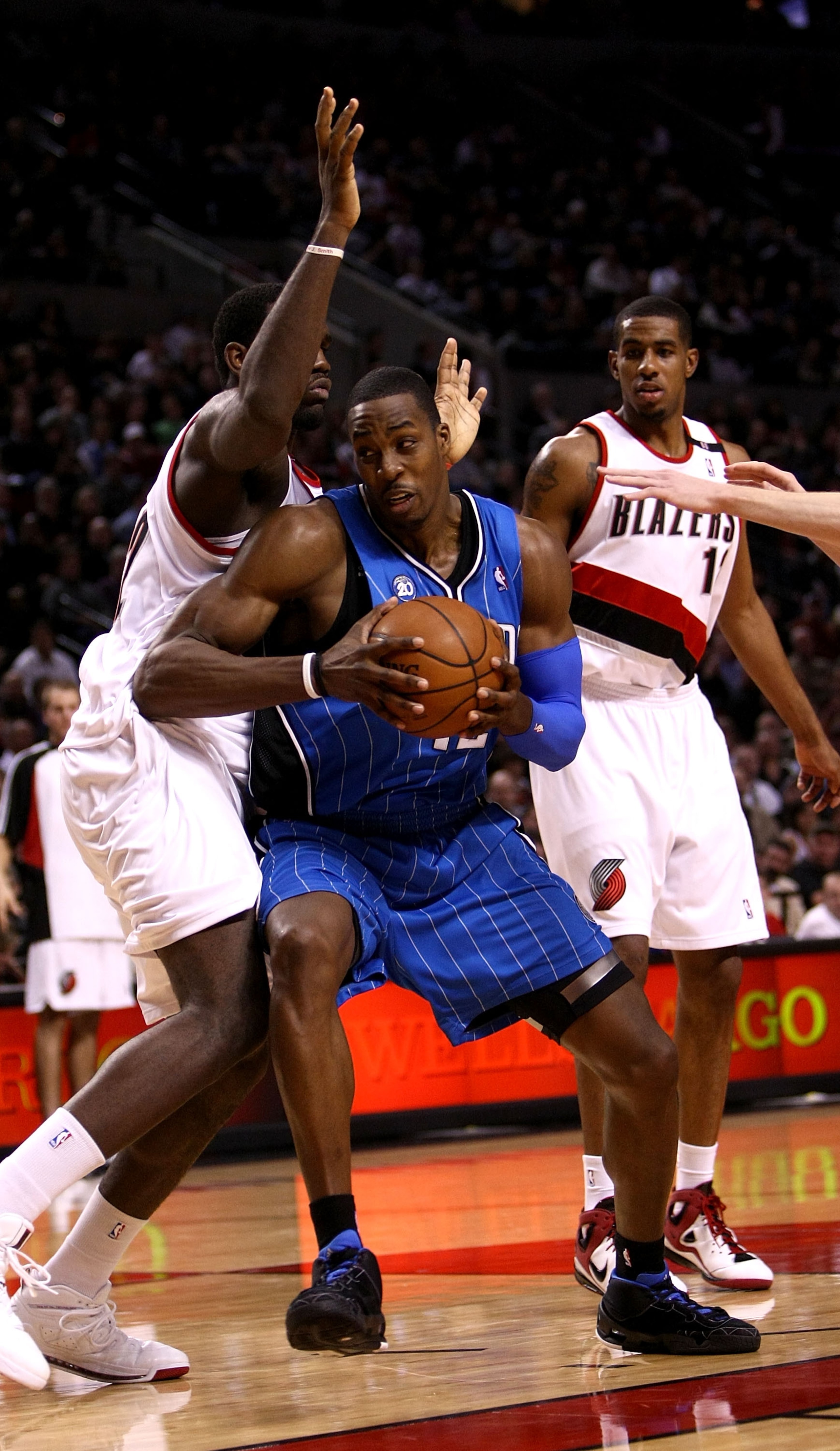 PORTLAND, OR - DECEMBER 09:  Dwight Howard #12 of the Orlando Magic drives against Greg Oden #52 of the Portland Trail Blazers at the Rose Garden on December 9, 2008 in Portland, Oregon.  NOTE TO USER: User expressly acknowledges and agrees that, by downl