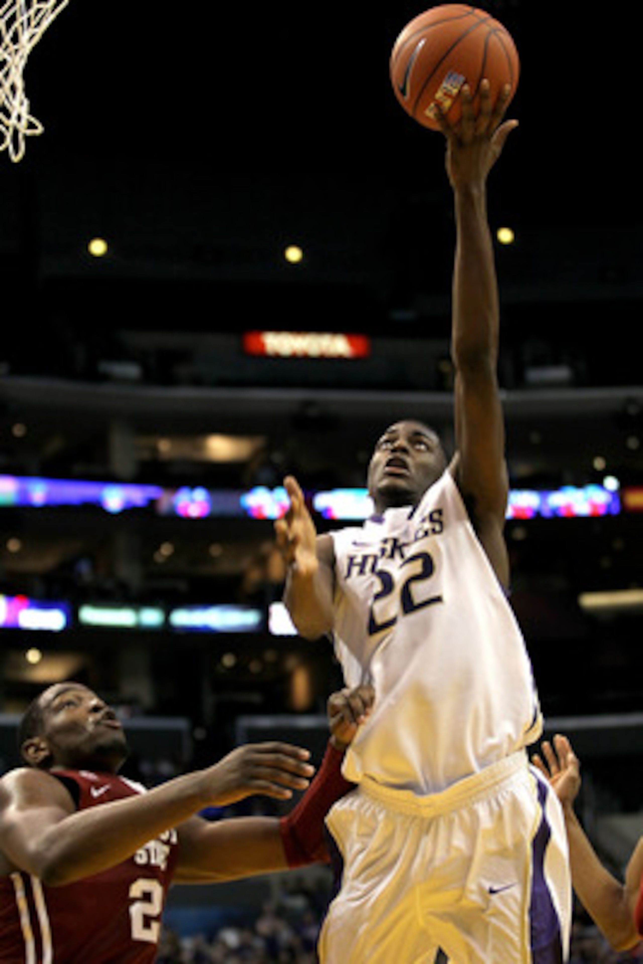 LOS ANGELES, CA - MARCH 10:  Justin Holiday #22 of the Washington Huskies lays the ball up in the first half against the Washington State Cougars in the quarterfinals of the 2011 Pacific Life Pac-10 Men's Basketball Tournament at Staples Center on March 1