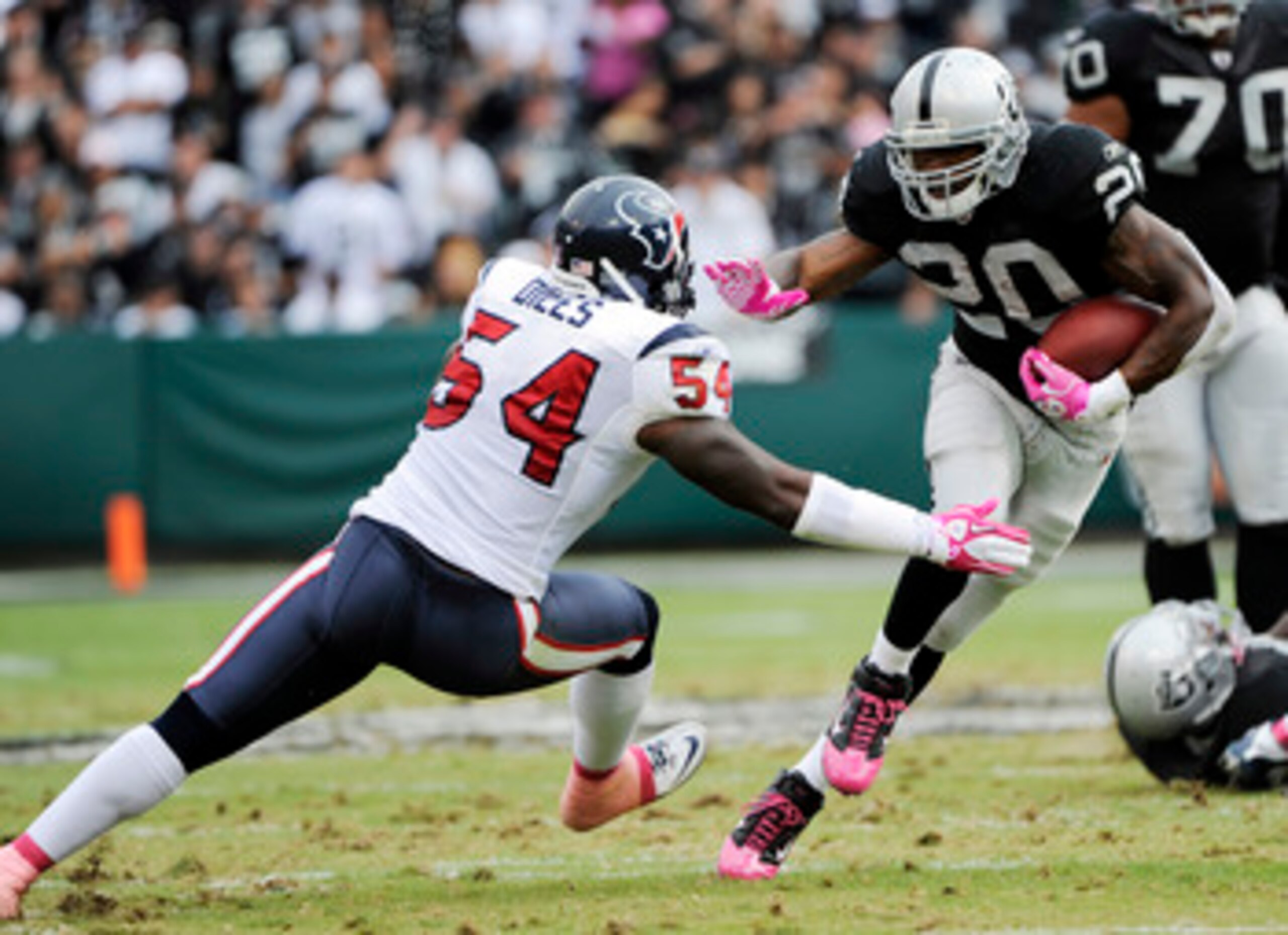 OAKLAND, CA - OCTOBER 3:  Running Back Darren McFadden #20 of the Oakland Raider tries to avoid the tackle of linebacker Zac Diles #54 of the Houston Texans during an NFL football game October 3, 2010 at The Oakland-Alameda County Coliseum in Oakland, Cal