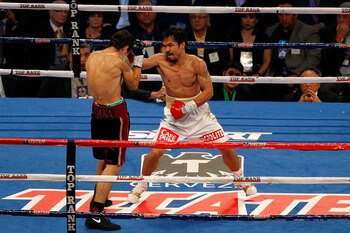 ARLINGTON, TX - NOVEMBER 13:  Manny Pacquiao (white trunks) of the Philippines fights against Antonio Margarito (black trunks) of Mexico during their WBC World Super Welterweight Title bout at Cowboys Stadium on November 13, 2010 in Arlington, Texas.  (Ph