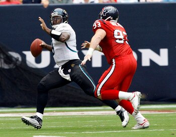 HOUSTON - SEPTEMBER 27:  Quarterback David Garrard #9 of the Jacksonville Jaguars runs out of the pocket as he his pursued by defensive end Tim Bulman #93 of the Houston Texans at Reliant Stadium on September 27, 2009 in Houston, Texas.  (Photo by Bob Lev
