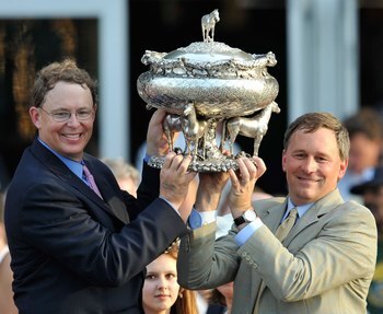 ELMONT, NY - JUNE 05:  Elliott Walden, Racing manager for WinStar Farms and trainer Bill Mott on the right hoist the Belmont trophy after their horse Drosselmeyer won the142nd Belmont Stakes at Belmont Park on June 5, 2010 in Elmont, New York.  (Photo by 