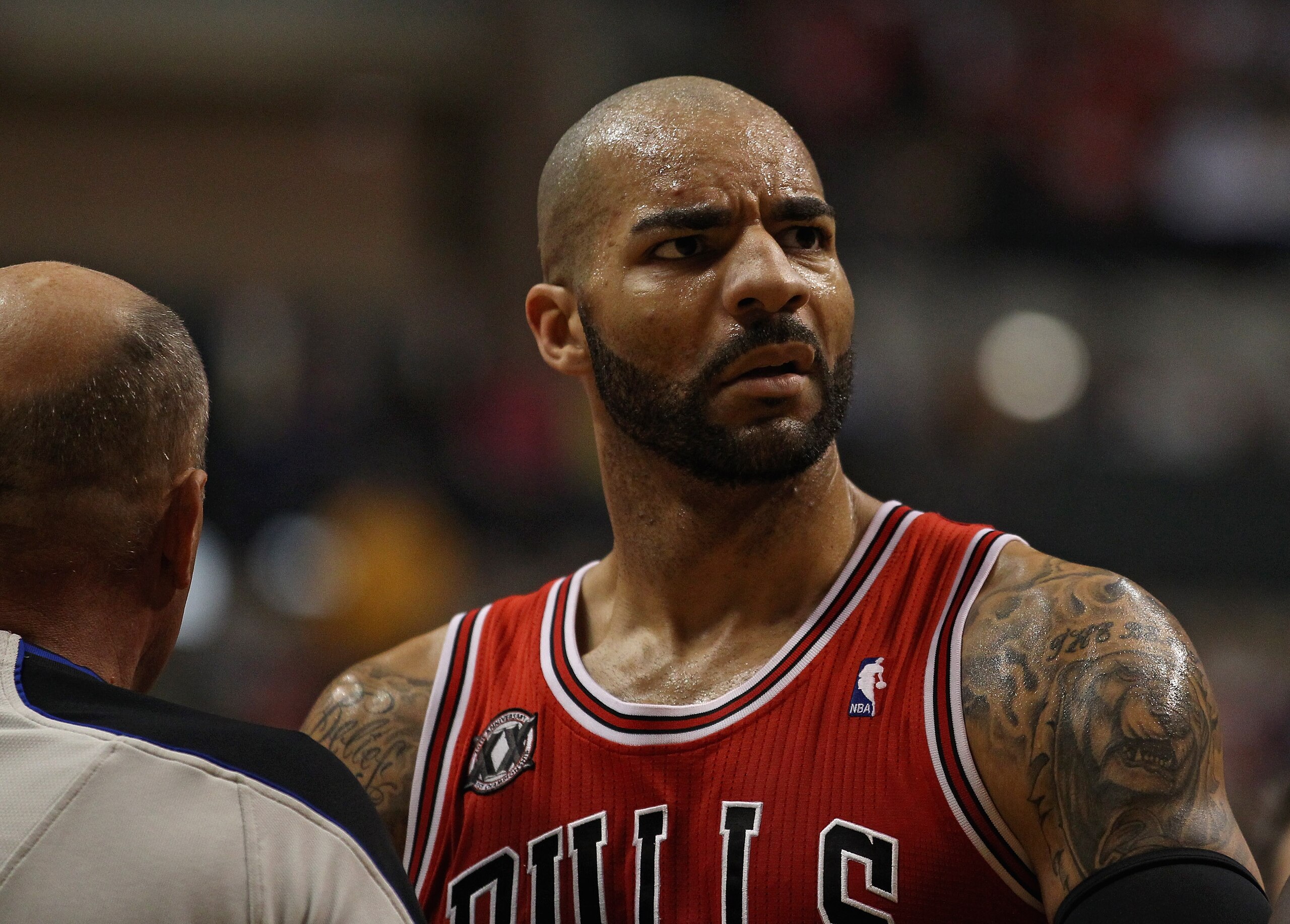 INDIANAPOLIS, IN - APRIL 23: Carlos Boozer #5 of the Chicago Bulls stares at Roy Hibbert of the Indiana Pacers in Game Four of the Eastern Conference Quarterfinals in the 2011 NBA Playoffs at Conseco Fieldhouse on April 23, 2011 in Indianapolis, Indiana.