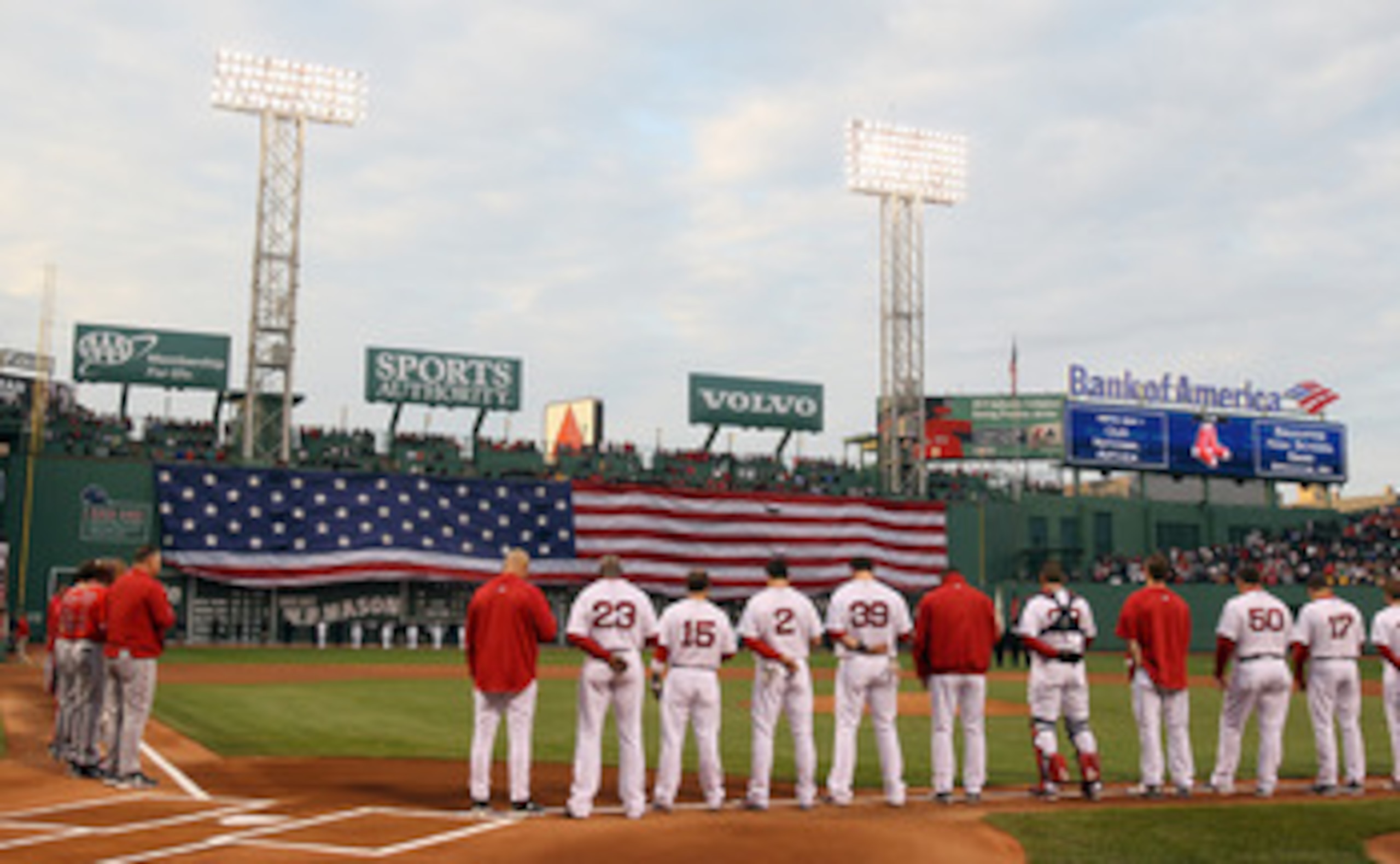 BOSTON, MA - MAY 02: The Boston Red Sox and the Los Angeles Angels watch the flag cover the Green Monster as the national anthem is played on May 2, 2011 at Fenway Park in Boston, Massachusetts. Both teams lined up on the baseline to observe a moment of BOSTON, MA - MAY 02: The Boston Red Sox and the Los Angeles Angels watch the flag cover the Green Monster as the national anthem is played on May 2, 2011 at Fenway Park in Boston, Massachusetts. Both teams lined up on the baseline to observe a moment of