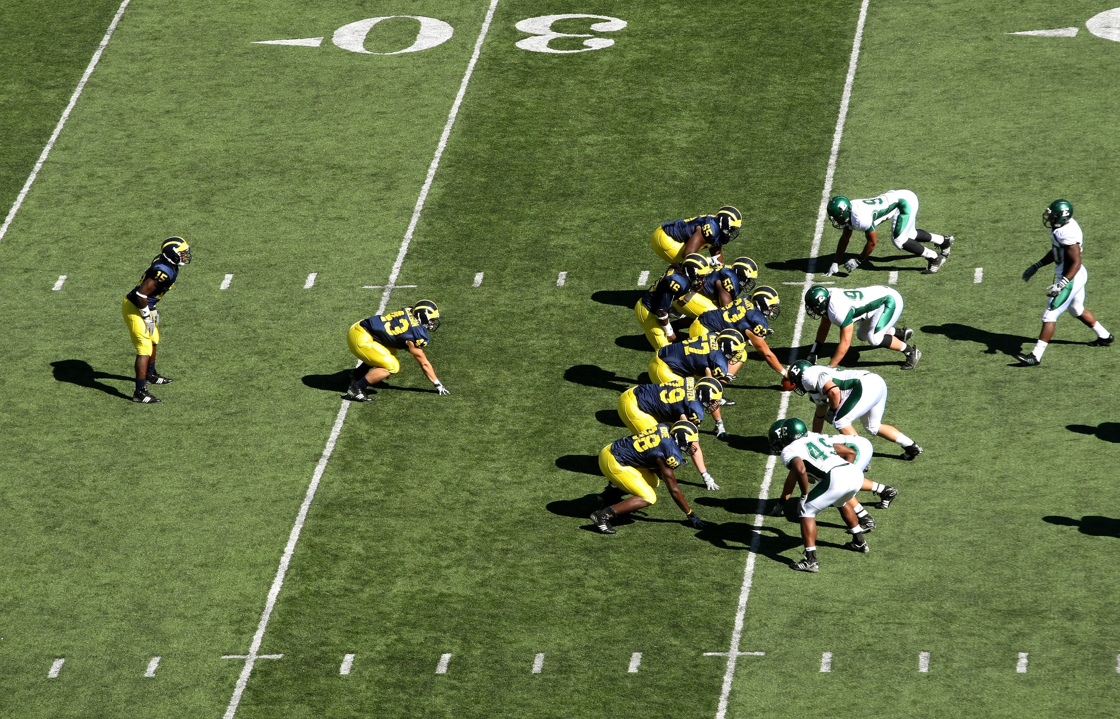 ANN ARBOR, MI - SEPTEMBER 19:  The Michigan Wolverines  offense sets on the line of scrimmage agaisnt the Eastern Michigan Eagles at Michigan Stadium on September 19, 2009 in Ann Arbor, Michigan.  Michigan won 45-17.  (Photo by Stephen Dunn/Getty Images)