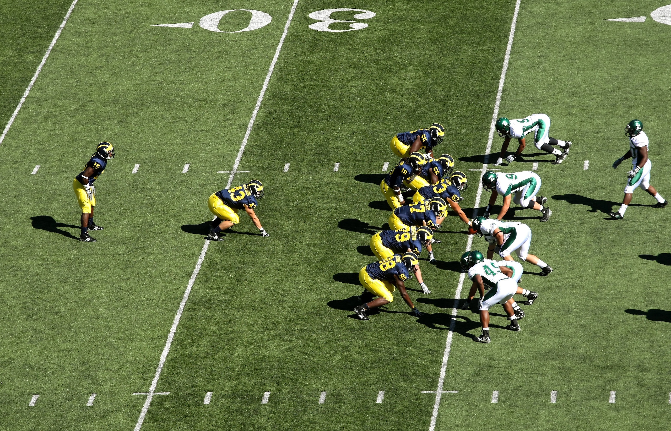 ANN ARBOR, MI - SEPTEMBER 19:  The Michigan Wolverines  offense sets on the line of scrimmage agaisnt the Eastern Michigan Eagles at Michigan Stadium on September 19, 2009 in Ann Arbor, Michigan.  Michigan won 45-17.  (Photo by Stephen Dunn/Getty Images)