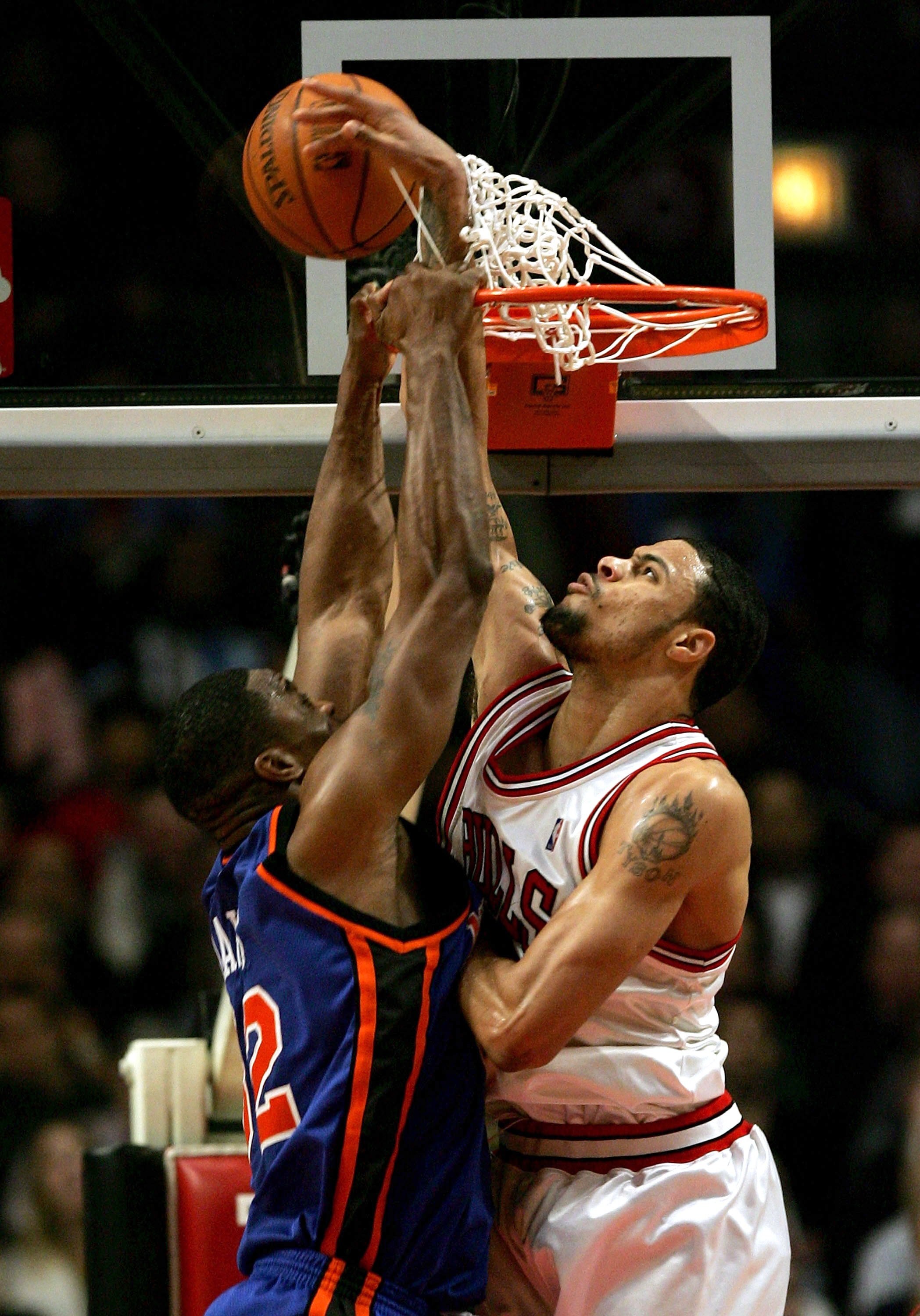 CHICAGO - JANUARY 18:  Tyson Chandler #3 of the Chicago Bulls reaches through the basket to block a shot by Antonio Davis #32 of the New York Knicks and is called for goaltending on January 18, 2006 at the United Center in Chicago, Illinois. The Bulls def