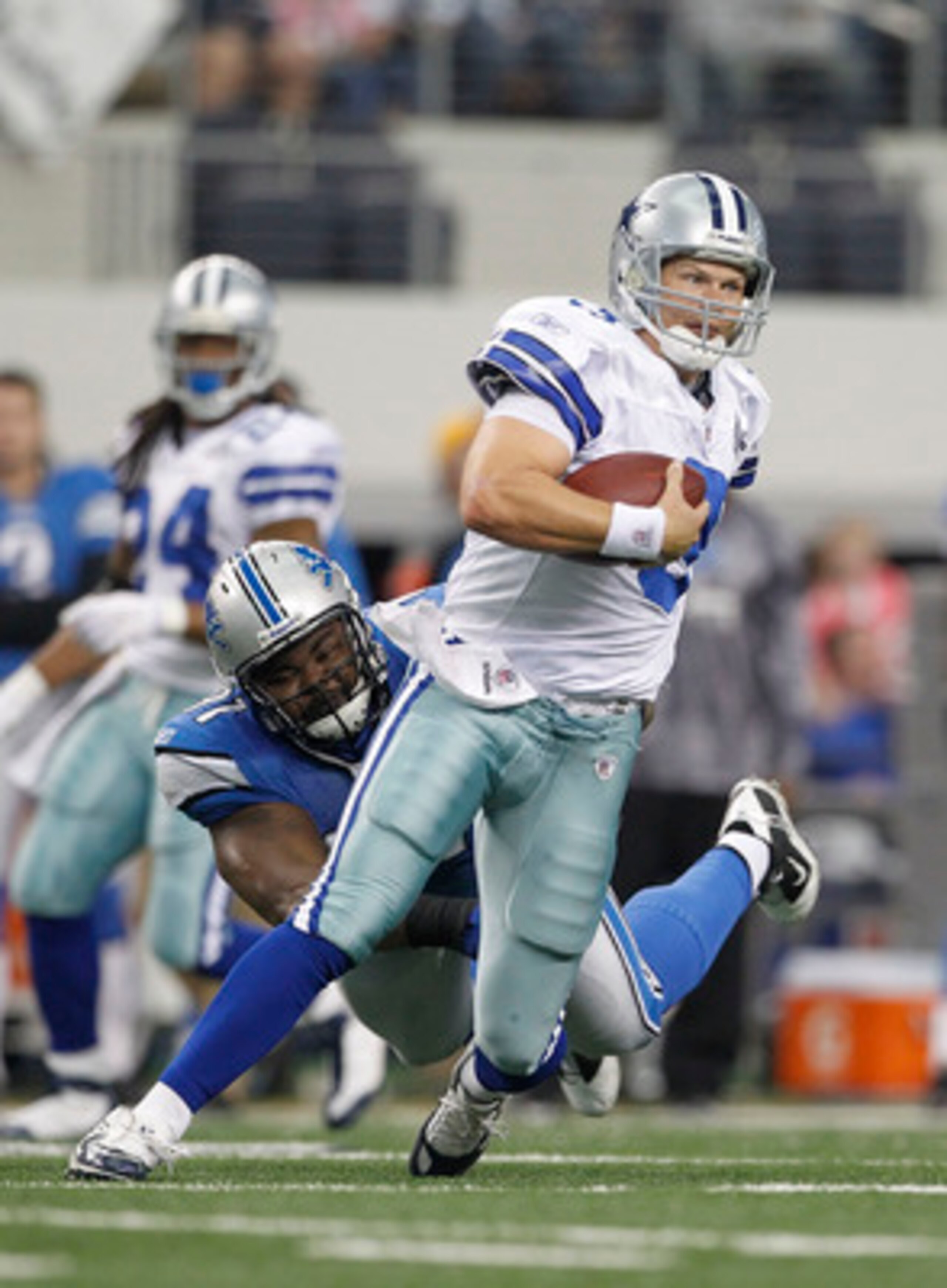 ARLINGTON, TX - NOVEMBER 21: Jon Kitna #3 of the Dallas Cowboys breaks the tackle of Andre Fluellen #96 of the Detroit Lions and runs 29 yards for a fourth quarter touchdown at Dallas Stadium on November 21, 2010 in Arlington, Texas. The Cowboys defeated ARLINGTON, TX - NOVEMBER 21: Jon Kitna #3 of the Dallas Cowboys breaks the tackle of Andre Fluellen #96 of the Detroit Lions and runs 29 yards for a fourth quarter touchdown at Dallas Stadium on November 21, 2010 in Arlington, Texas. The Cowboys defeated