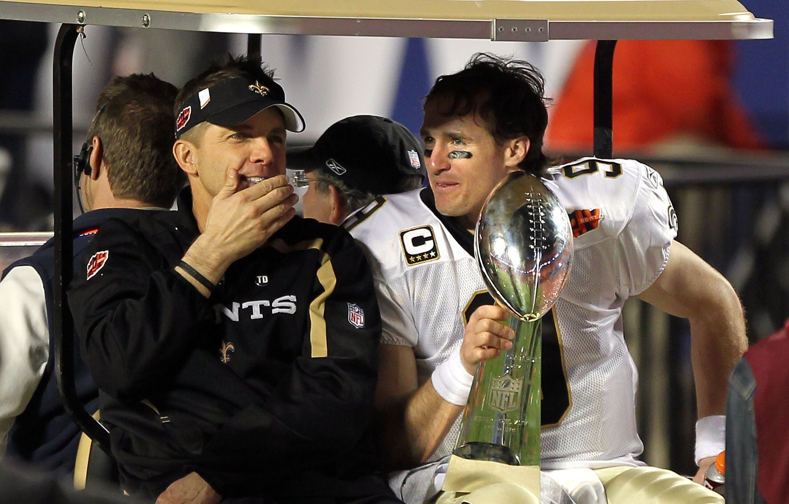 MIAMI GARDENS, FL - FEBRUARY 07:  Head coach Sean Payton of the New Orleans Saints and quarterback Drew Brees #9 leave the field in a golf cart after defeating the Indianapolis Colts during Super Bowl XLIV on February 7, 2010 at Sun Life Stadium in Miami