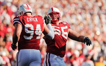 LINCOLN, NE - OCTOBER 30: Defensive tackle Baker Steinkuhler #55  of the Nebraska Cornhuskers high fives teammate  defensive tackle Jared Crick #94 after a third down stop during second half action of their game at Memorial Stadium on October 30, 2010 in