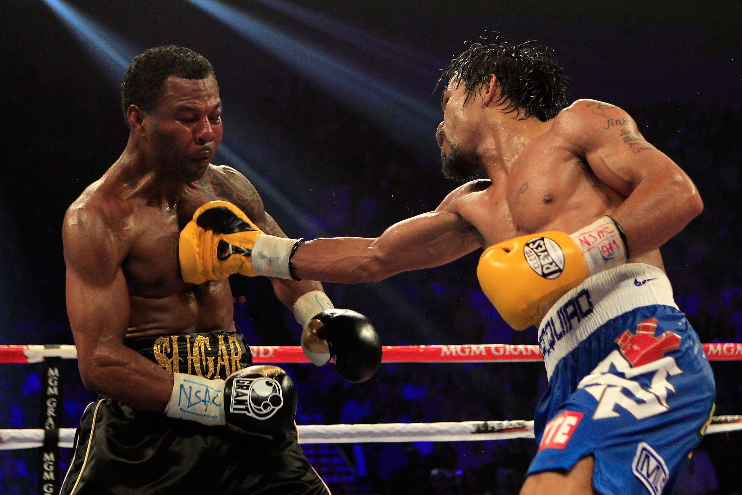 LAS VEGAS, NV - MAY 07:  (R-L) Manny Pacquiao of the Philippines throws a right to the body of Shane Mosley in the WBO welterweight title fight at MGM Grand Garden Arena on May 7, 2011 in Las Vegas, Nevada.  (Photo by Chris Trotman/Getty Images)
