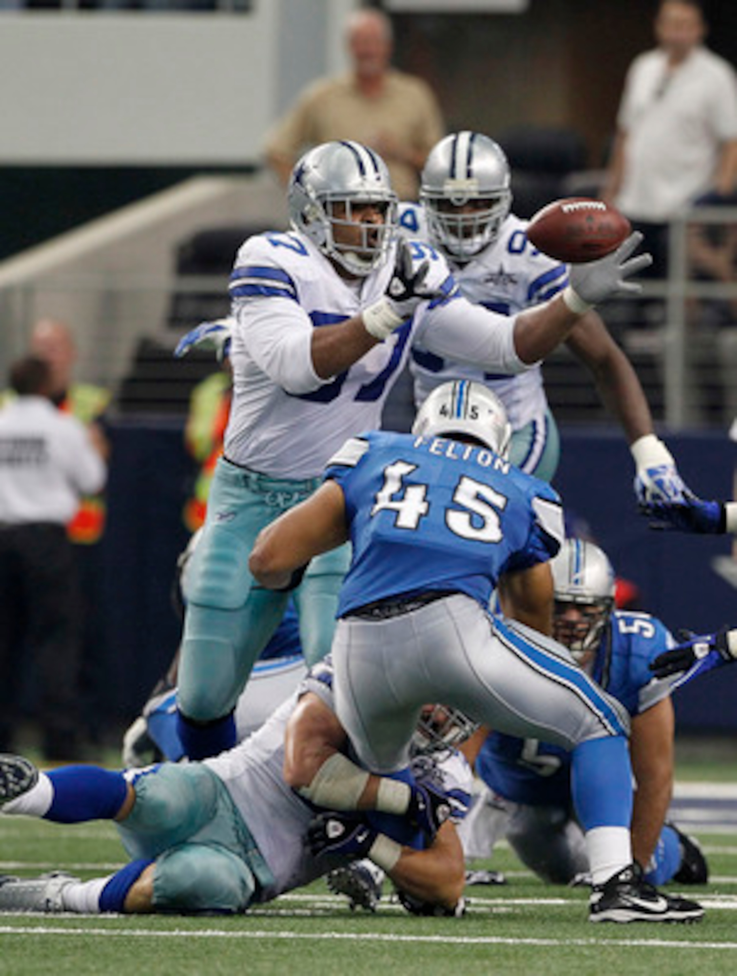 ARLINGTON, TX - NOVEMBER 21: Jerome Felton #45 of the Detroit Lions fumbles the ball during the third quarter as Jason Hatcher #97 of the Dallas Cowboys attempts to catch the ball at Dallas Stadium on November 21, 2010 in Arlington, Texas. The ball was re ARLINGTON, TX - NOVEMBER 21: Jerome Felton #45 of the Detroit Lions fumbles the ball during the third quarter as Jason Hatcher #97 of the Dallas Cowboys attempts to catch the ball at Dallas Stadium on November 21, 2010 in Arlington, Texas. The ball was re