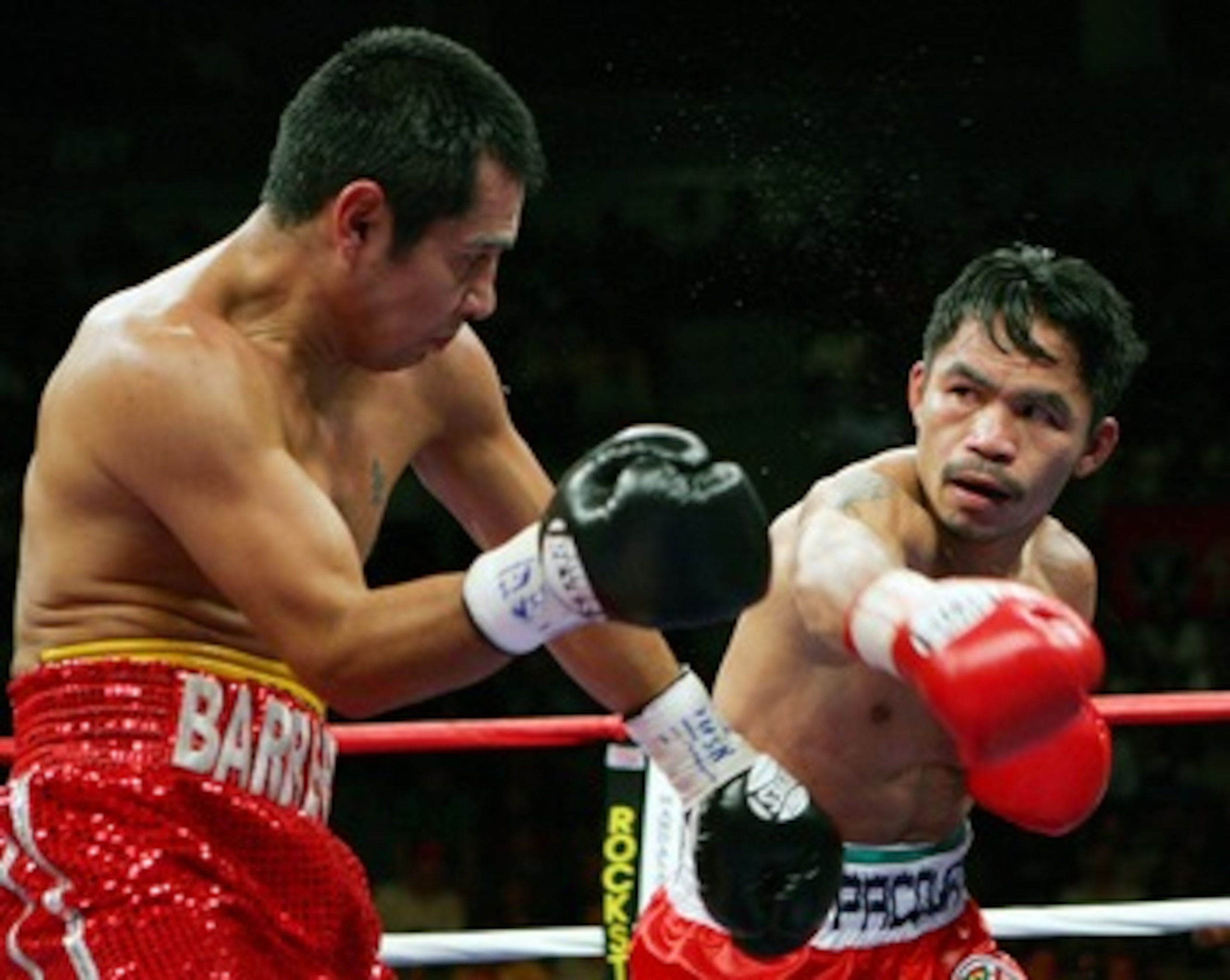 LAS VEGAS - OCTOBER 06:  Marco Antonio Barrera (L) and Manny Pacquiao trade punches in the fifth round of their 12-round super featherweight bout at the Mandalay Bay Events Center October 6, 2007 in Las Vegas, Nevada. Pacquiao won by unanimous decision.