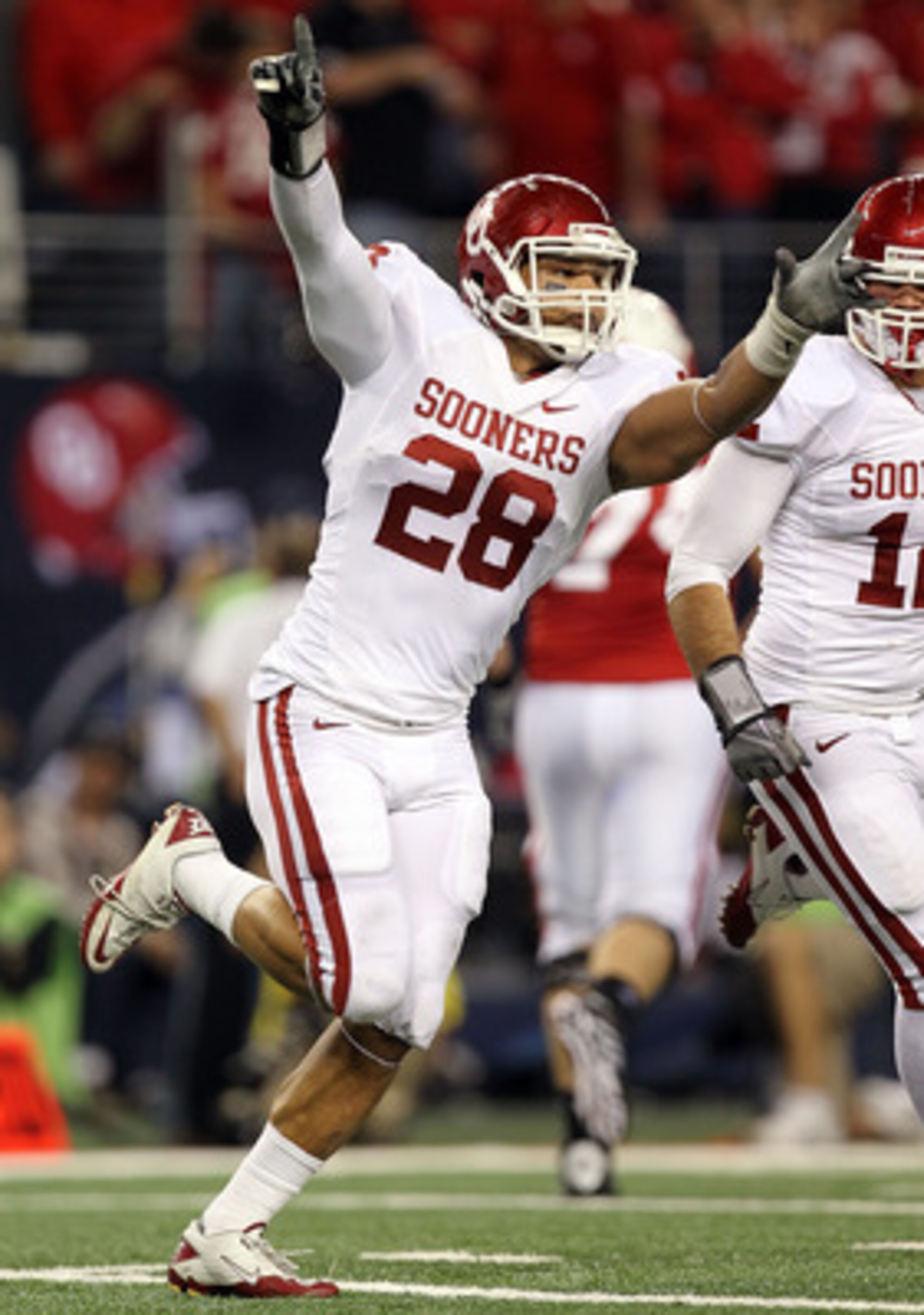 ARLINGTON, TX - DECEMBER 04: Linebacker Travis Lewis #28 of the Oklahoma Sooners celebrate a pass interception against the Nebraska Cornhuskers during the Big 12 Championship at Cowboys Stadium on December 4, 2010 in Arlington, Texas. (Photo by Ronald M ARLINGTON, TX - DECEMBER 04: Linebacker Travis Lewis #28 of the Oklahoma Sooners celebrate a pass interception against the Nebraska Cornhuskers during the Big 12 Championship at Cowboys Stadium on December 4, 2010 in Arlington, Texas. (Photo by Ronald M