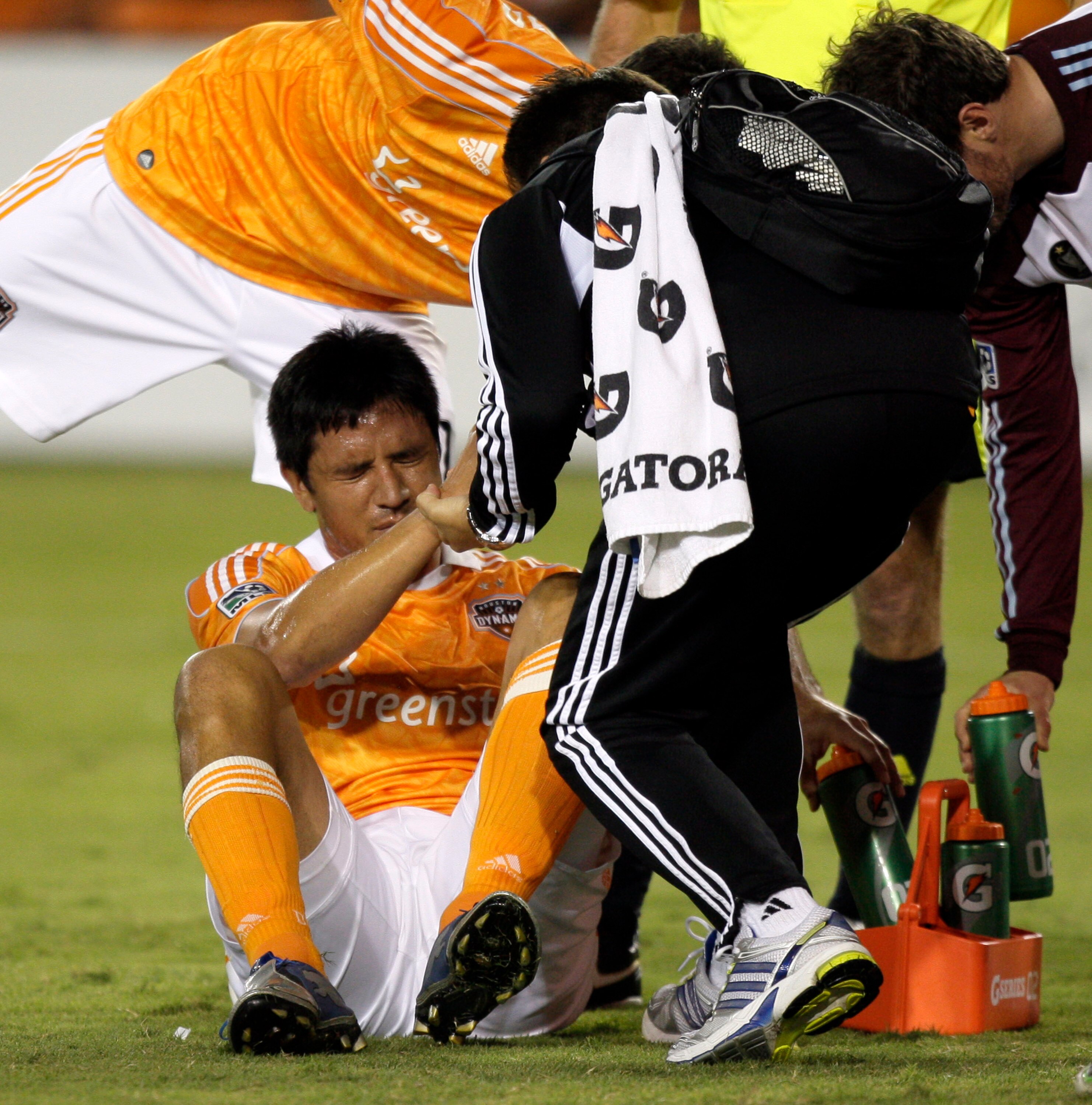HOUSTON - MAY 04:  Brian Ching #25 of the Houston Dynamo is helped up after being shaken up in the second half against the Colorado Rapids at Robertson Stadium on May 4, 2011 in Houston, Texas.  (Photo by Bob Levey/Getty Images)