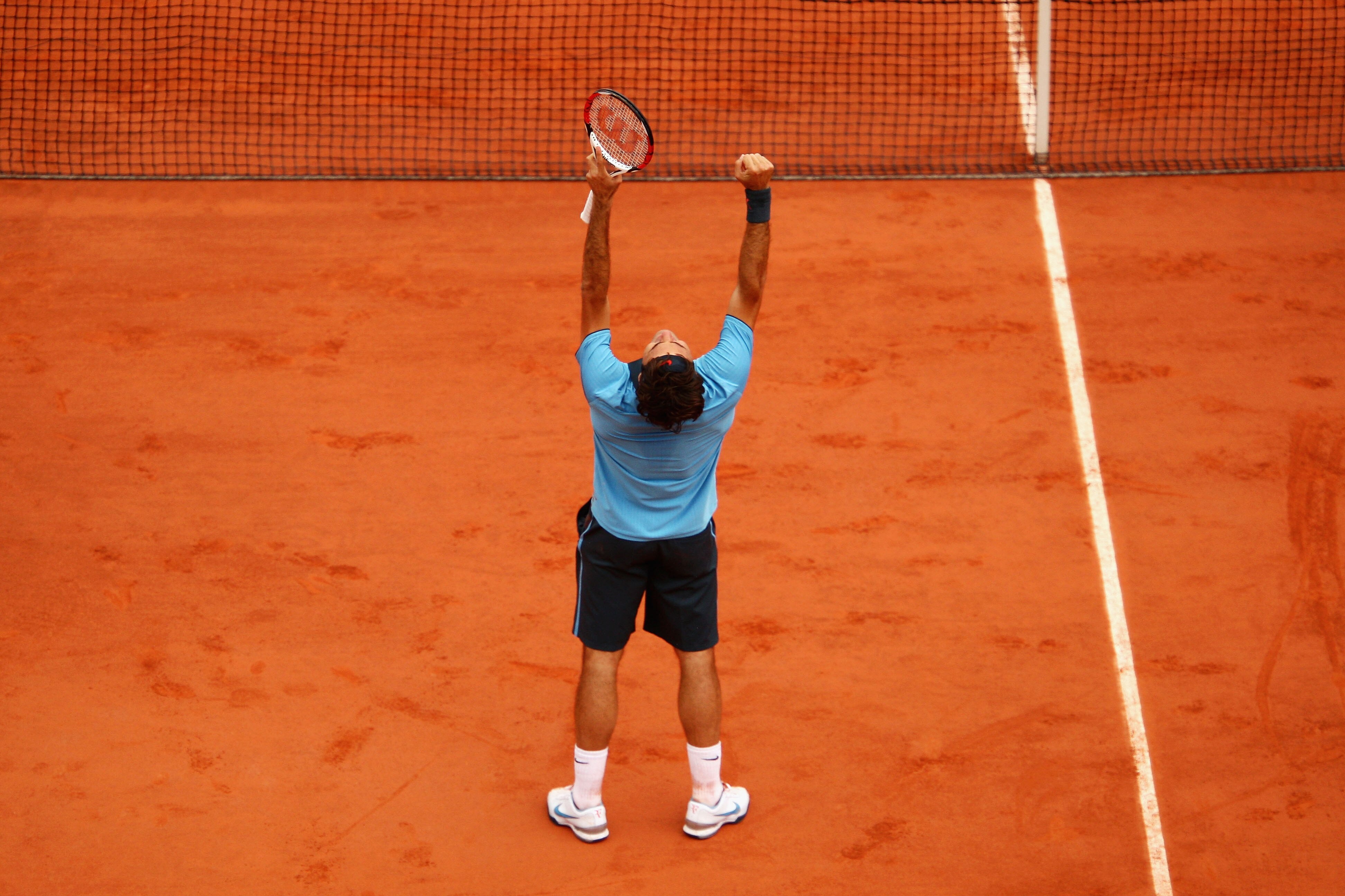 PARIS - JUNE 07:  Roger Federer of Switzerland celebrates victory during the Men's Singles Final match against Robin Soderling of Sweden on day fifteen of the French Open at Roland Garros on June 7, 2009 in Paris, France.  (Photo by Clive Brunskill/Getty