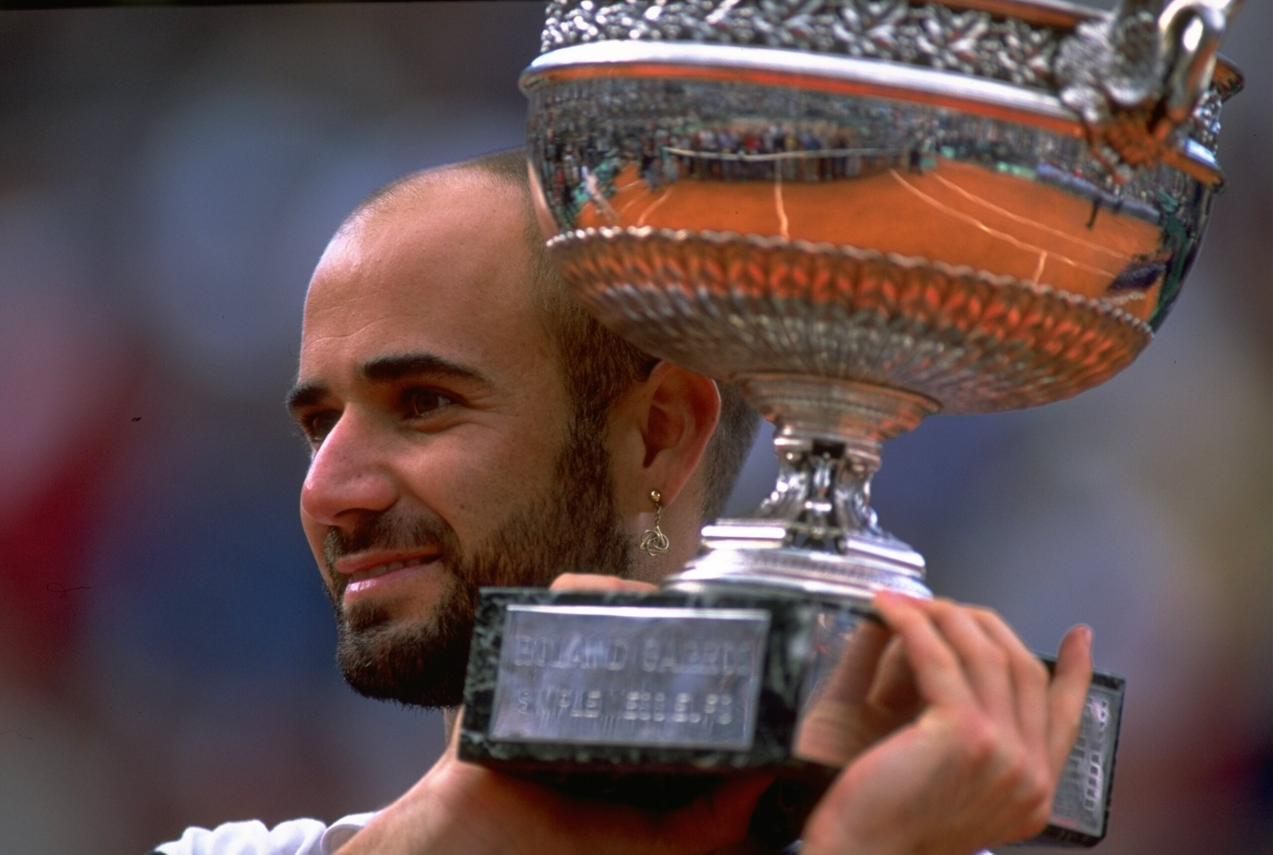 6 Jun 1999:  Andre Agassi of the United States celebrates victory with the trophy during the 1999 French Open Final match against Andrei Medvedev of the Ukraine played at Roland Garros in Paris, France.  The match finished in an emotional victory for Andr