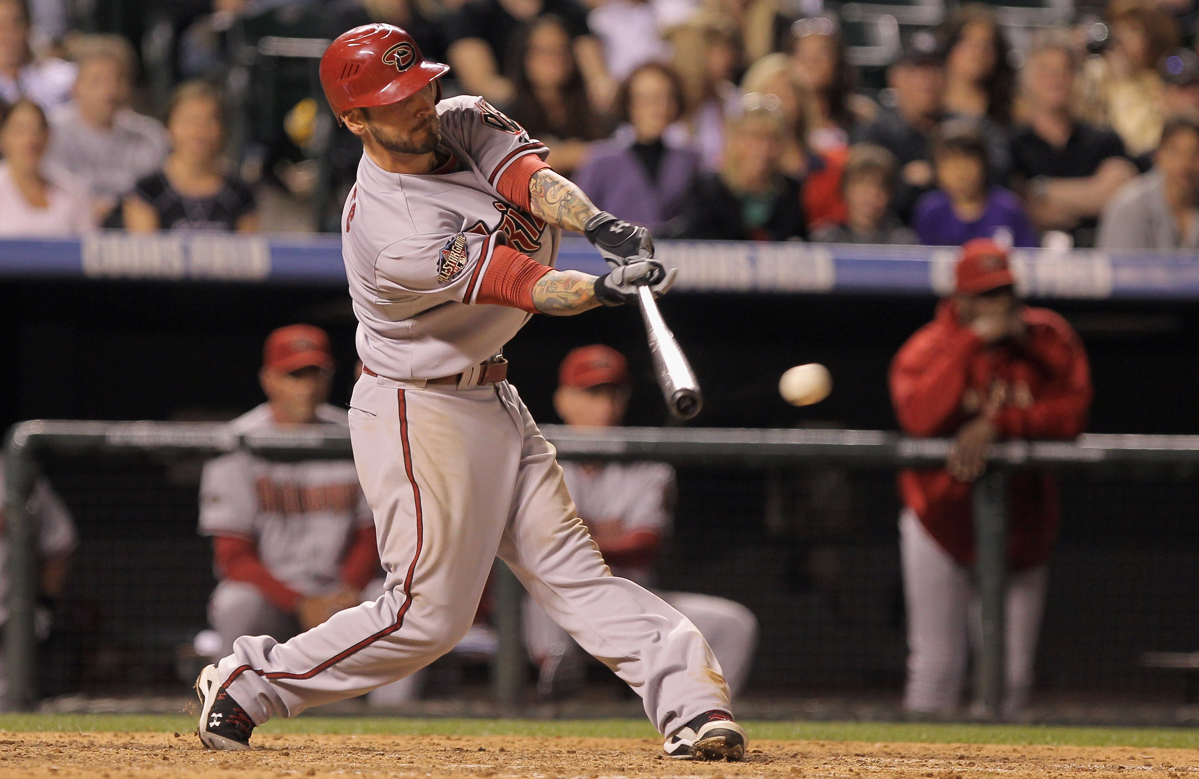 DENVER, CO - APRIL 02:  Ryan Roberts #14 of the Arizona Diamondbacks delivers a base hit in the ninth inning against pitcher Huston Street #16 of the Colorado Rockies at Coors Field on April 2, 2011 in Denver, Colorado.  (Photo by Doug Pensinger/Getty Ima