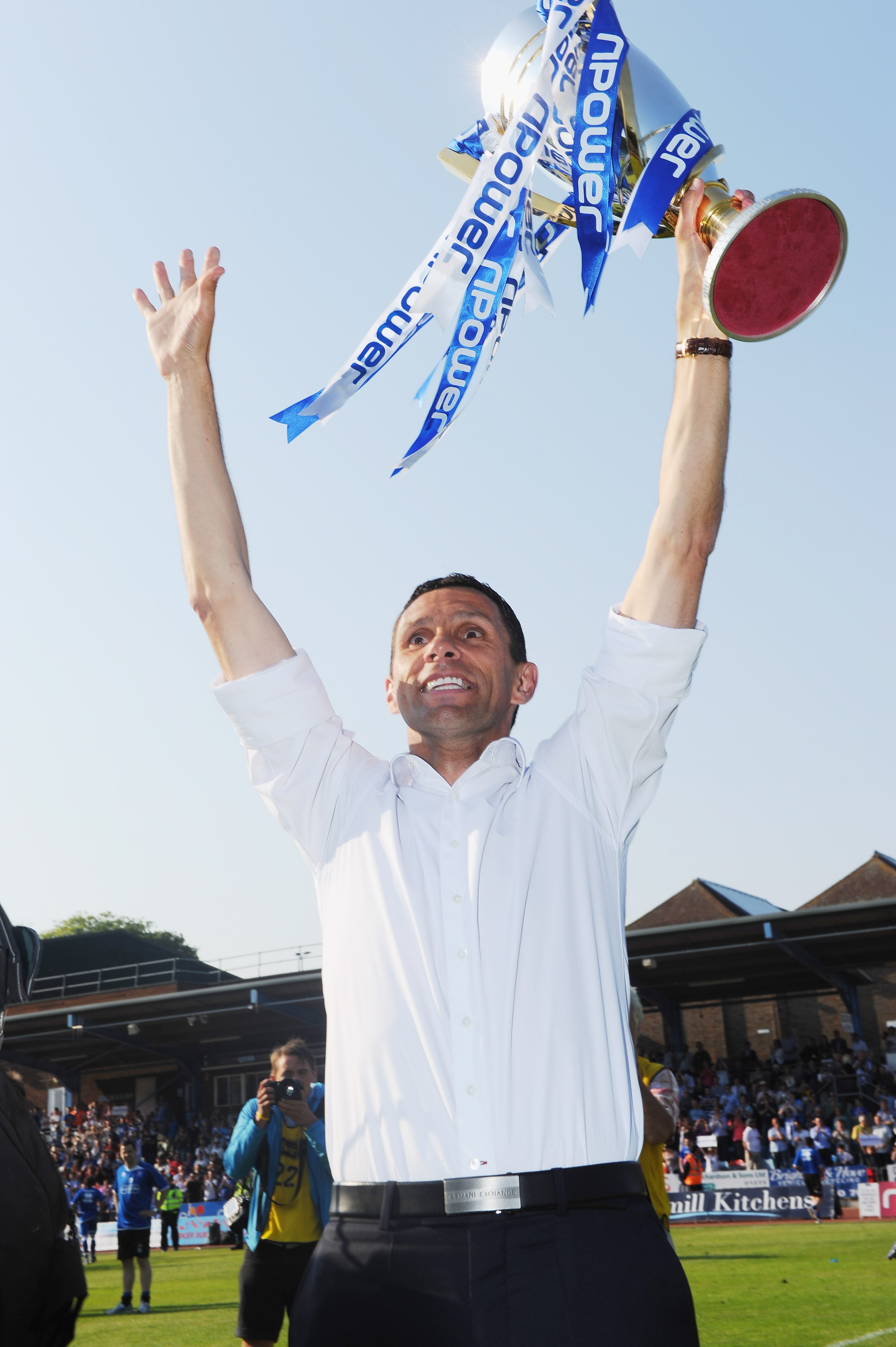 BRIGHTON, ENGLAND - APRIL 30: Brighton manager Gus Poyet holds aloft the Division One trophy after the npower League One match between Brighton & Hove Albion and Huddersfield Town at Withdean Stadium on April 30, 2011 in Brighton, United Kingdom. (Phot BRIGHTON, ENGLAND - APRIL 30: Brighton manager Gus Poyet holds aloft the Division One trophy after the npower League One match between Brighton & Hove Albion and Huddersfield Town at Withdean Stadium on April 30, 2011 in Brighton, United Kingdom. (Phot