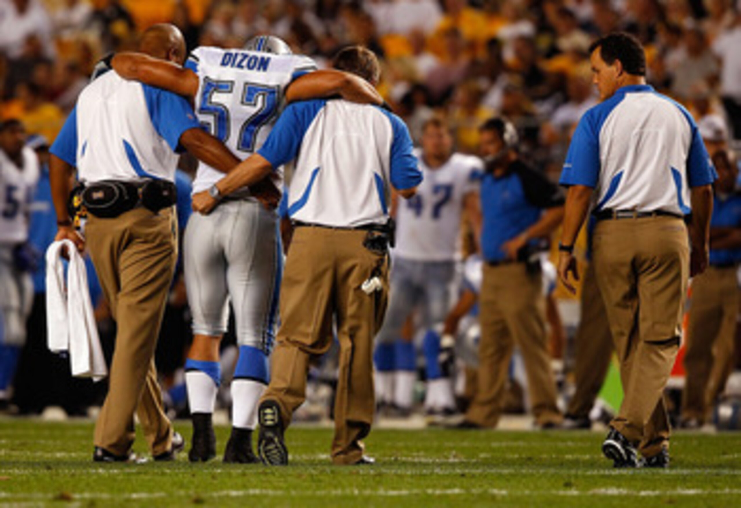 PITTSBURGH - AUGUST 14: Jordon Dizon #57 of the Detroit Lions walks off the field with the help of trainers after injuring himself during the preseason game against the Pittsburgh Steelers on August 14, 2010 at Heinz Field in Pittsburgh, Pennsylvania. ( PITTSBURGH - AUGUST 14: Jordon Dizon #57 of the Detroit Lions walks off the field with the help of trainers after injuring himself during the preseason game against the Pittsburgh Steelers on August 14, 2010 at Heinz Field in Pittsburgh, Pennsylvania. (