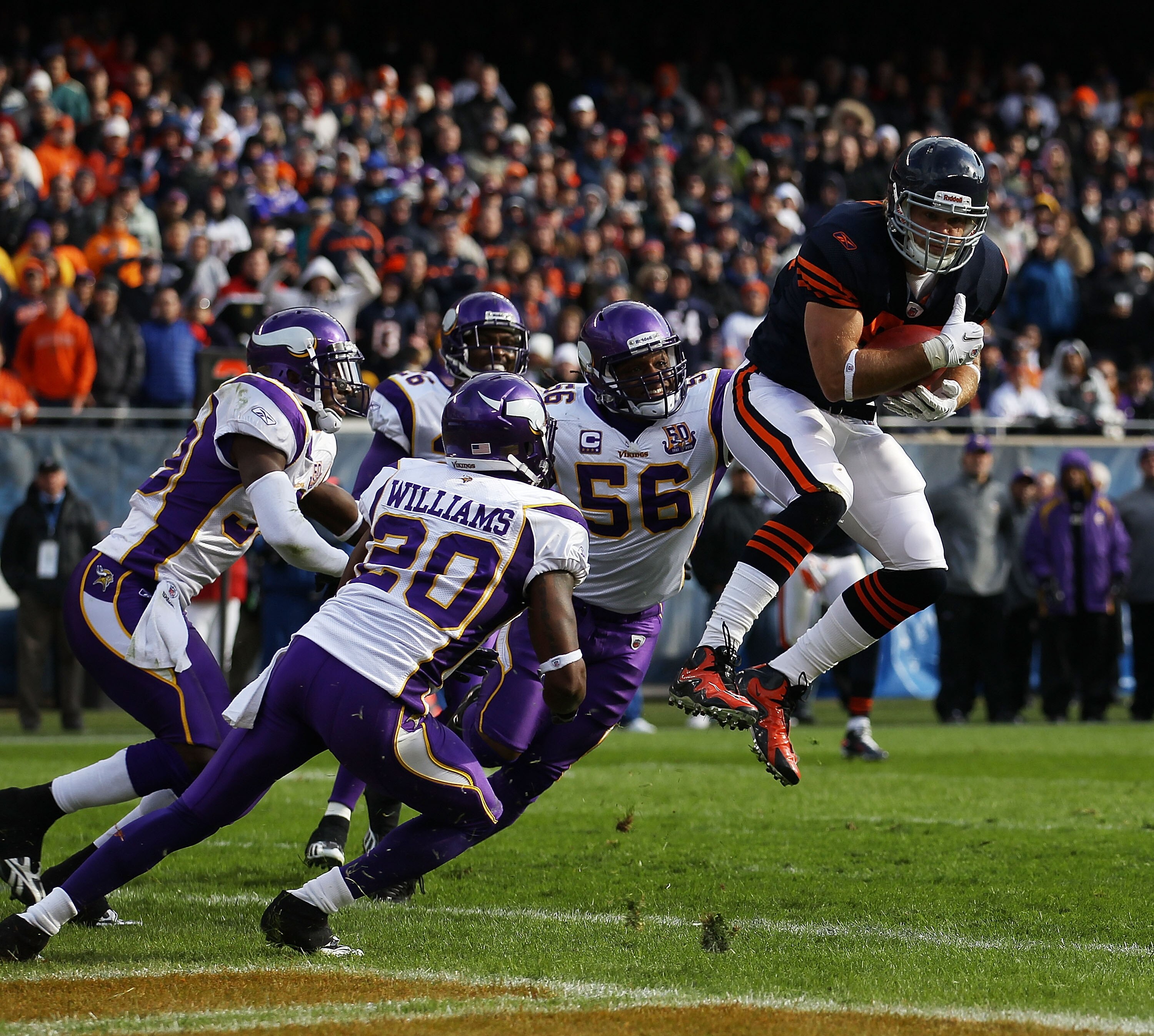 CHICAGO - NOVEMBER 14: Greg Olsen #82 of the Chicago Bears catches a touchdown pass over E.J. Henderson #56 and Madieu Williams #20 of the Minnesota Vikings at Soldier Field on November 14, 2010 in Chicago, Illinois. (Photo by Jonathan Daniel/Getty Images