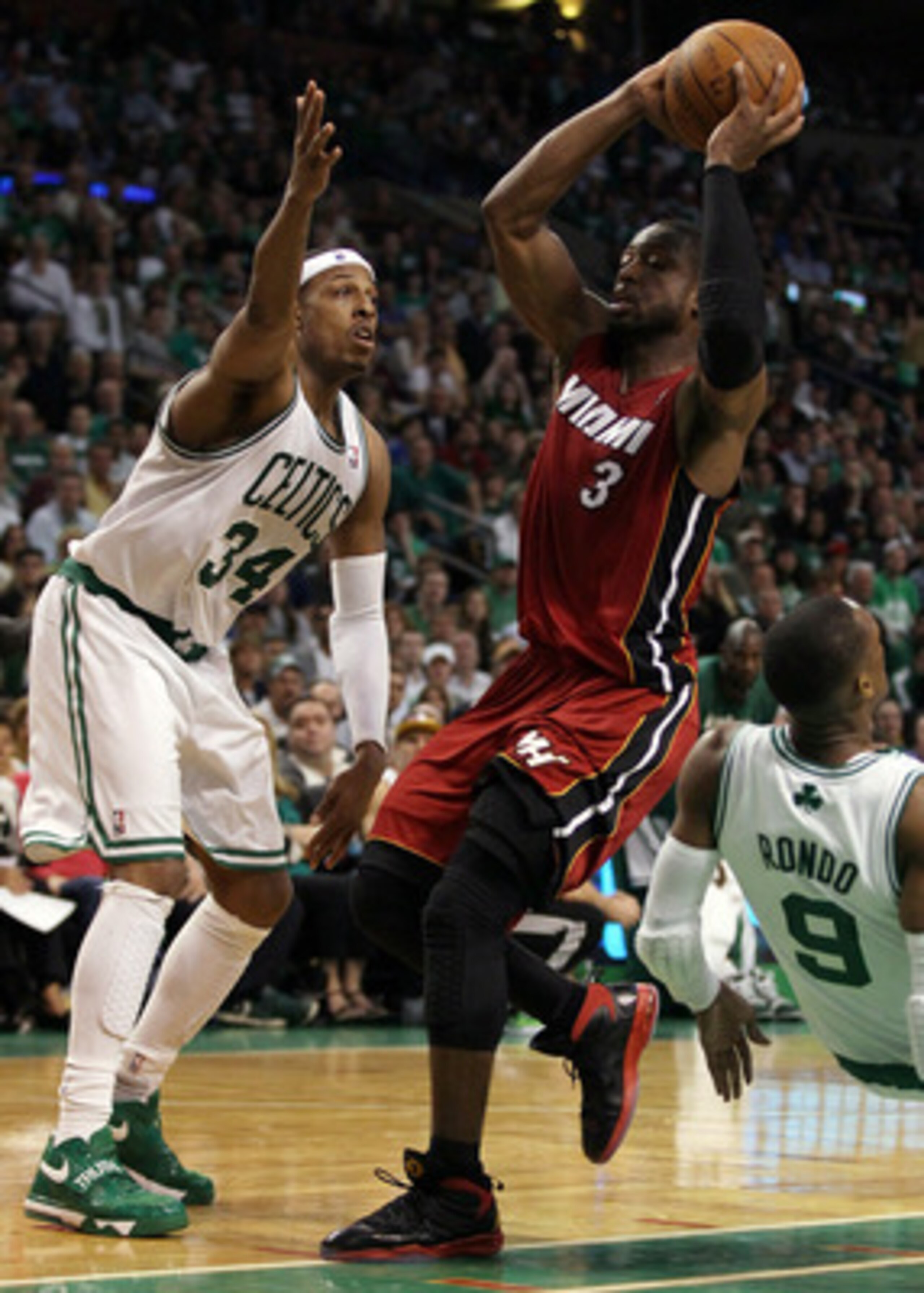 BOSTON, MA - MAY 07:  Dwyane Wade #3 of the Miami Heat heads for the basket as Rajon Rondo #9 and Paul Pierce #34 of the Boston Celtics defend in Game Three of the Eastern Conference Semifinals in the 2011 NBA Playoffs on May 7, 2011 at the TD Garden in B