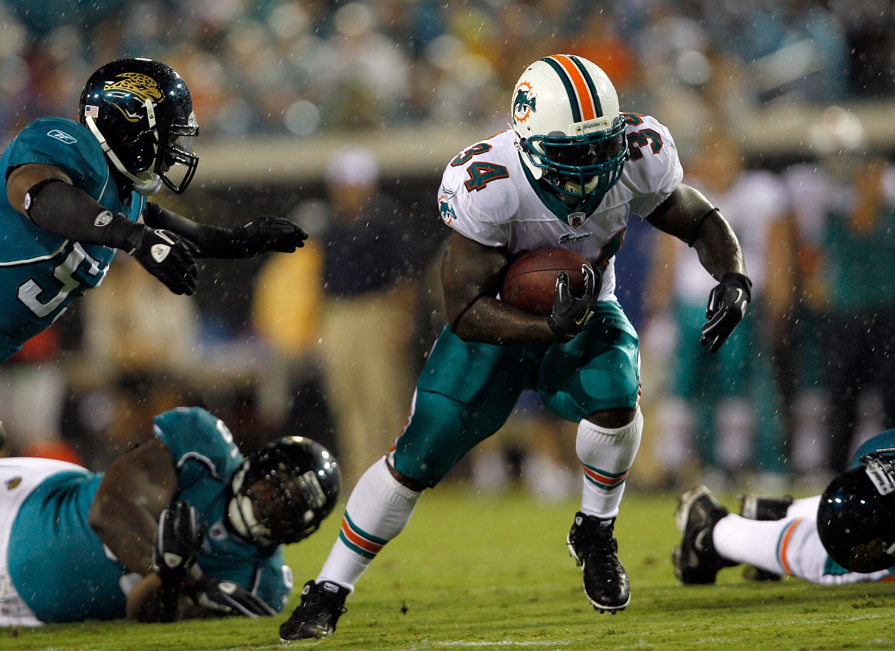 JACKSONVILLE, FL - AUGUST 21:  Ricky Williams #34 of the Miami Dolphins runs for yardage during the preseason game against the Jacksonville Jaguars at EverBank Field on August 21, 2010 in Jacksonville, Florida.  (Photo by Sam Greenwood/Getty Images)