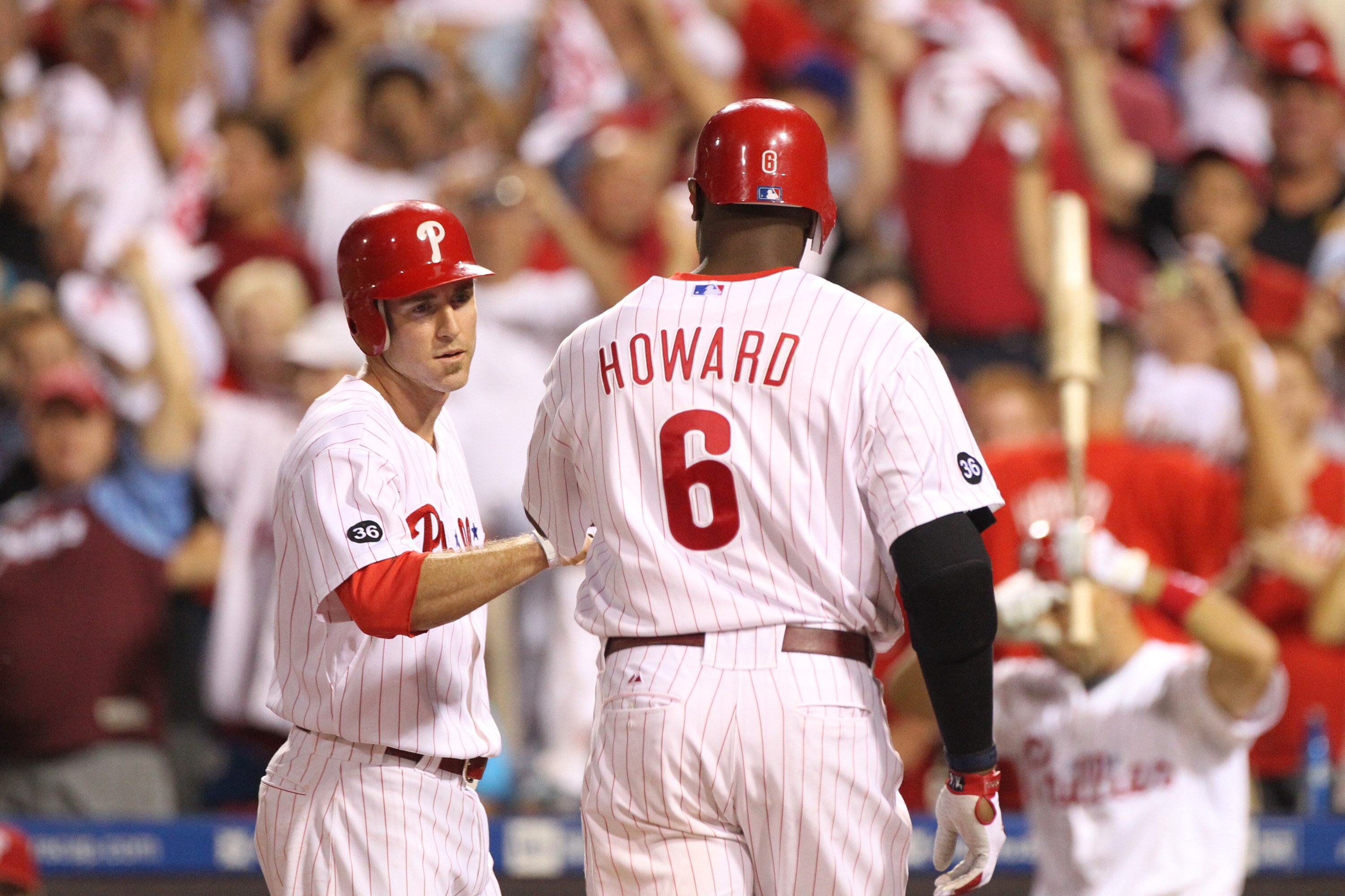 PHILADELPHIA - SEPTEMBER 25: First baseman Ryan Howard #6 of the Philadelphia Phillies is greeted at home plate by second baseman Chase Utley #26 after hitting a first inning two-run home run during a game against the New York Mets at Citizens Bank Park o