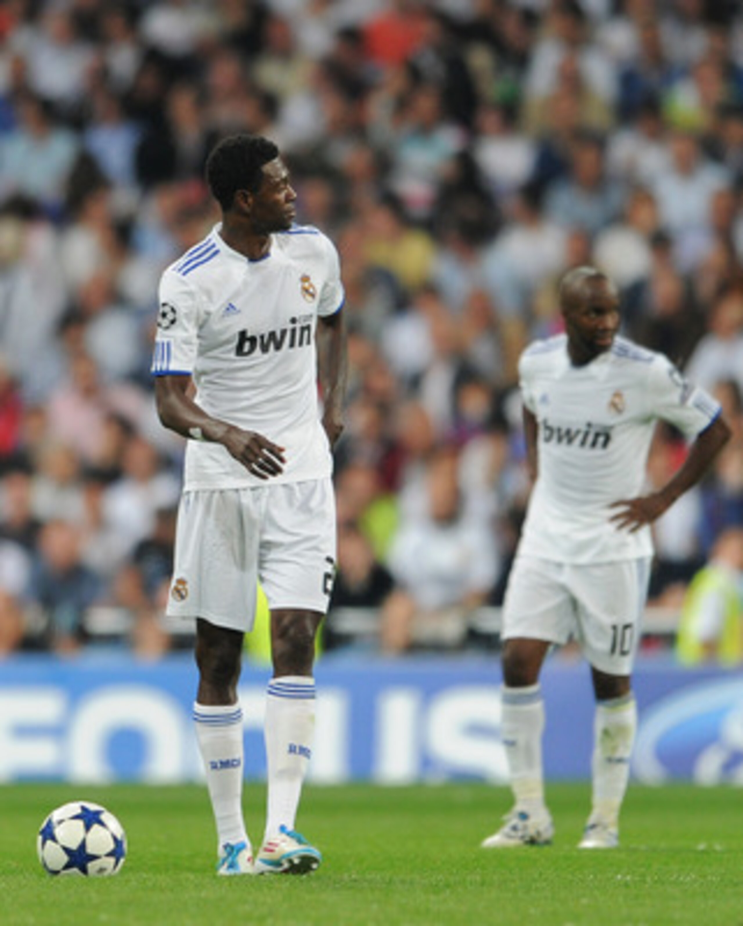 MADRID, SPAIN - APRIL 27: Emmanuel Adebayor (L) of Real Madrid trudges back to the halfway line backdropped by his teammate Lassana Diarra after conceding a goal during the UEFA Champions League Semi Final first leg match between Real Madrid and Barcelon MADRID, SPAIN - APRIL 27: Emmanuel Adebayor (L) of Real Madrid trudges back to the halfway line backdropped by his teammate Lassana Diarra after conceding a goal during the UEFA Champions League Semi Final first leg match between Real Madrid and Barcelon