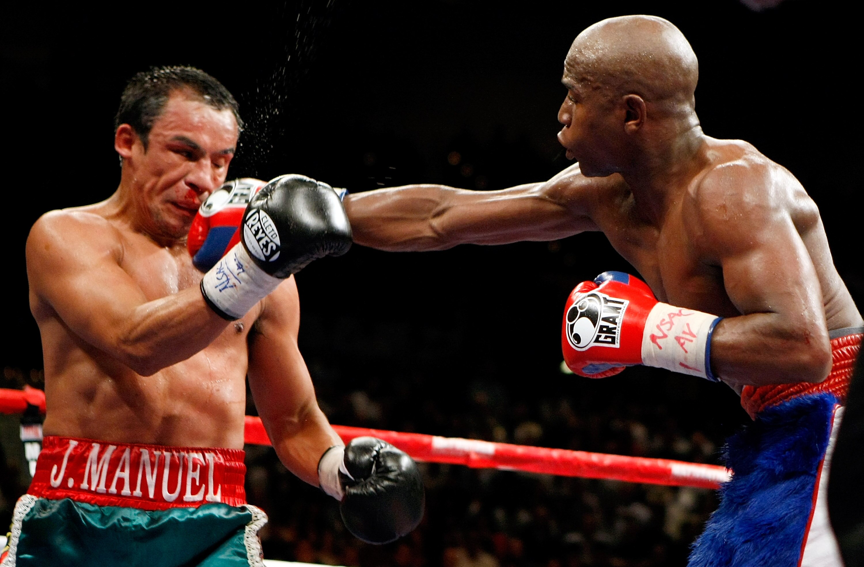 LAS VEGAS - SEPTEMBER 19:  Floyd Mayweather Jr. (R) hits Juan Manuel Marquez in the eighth round of their fight at the MGM Grand Garden Arena September 19, 2009 in Las Vegas, Nevada. Mayweather won by unanimous decision.  (Photo by Ethan Miller/Getty Imag