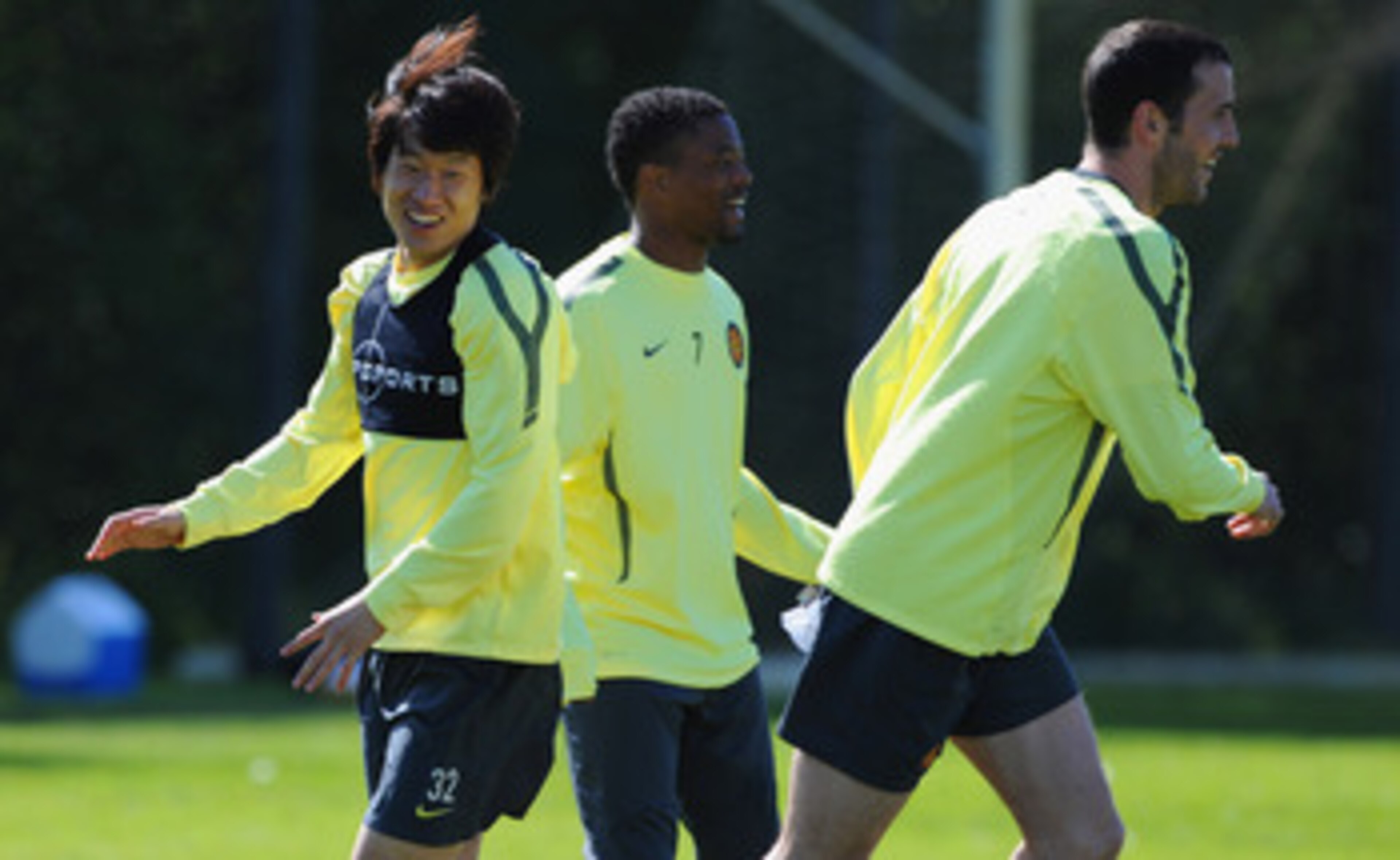 MANCHESTER, ENGLAND - MAY 03: Park Ji-Sung, Patrice Evra and John O'Shea look on during a training session ahead of their UEFA Champions League semi final second leg match against Schalke 04 at the Carrington Training Ground on May 3, 2011 in Manchester,