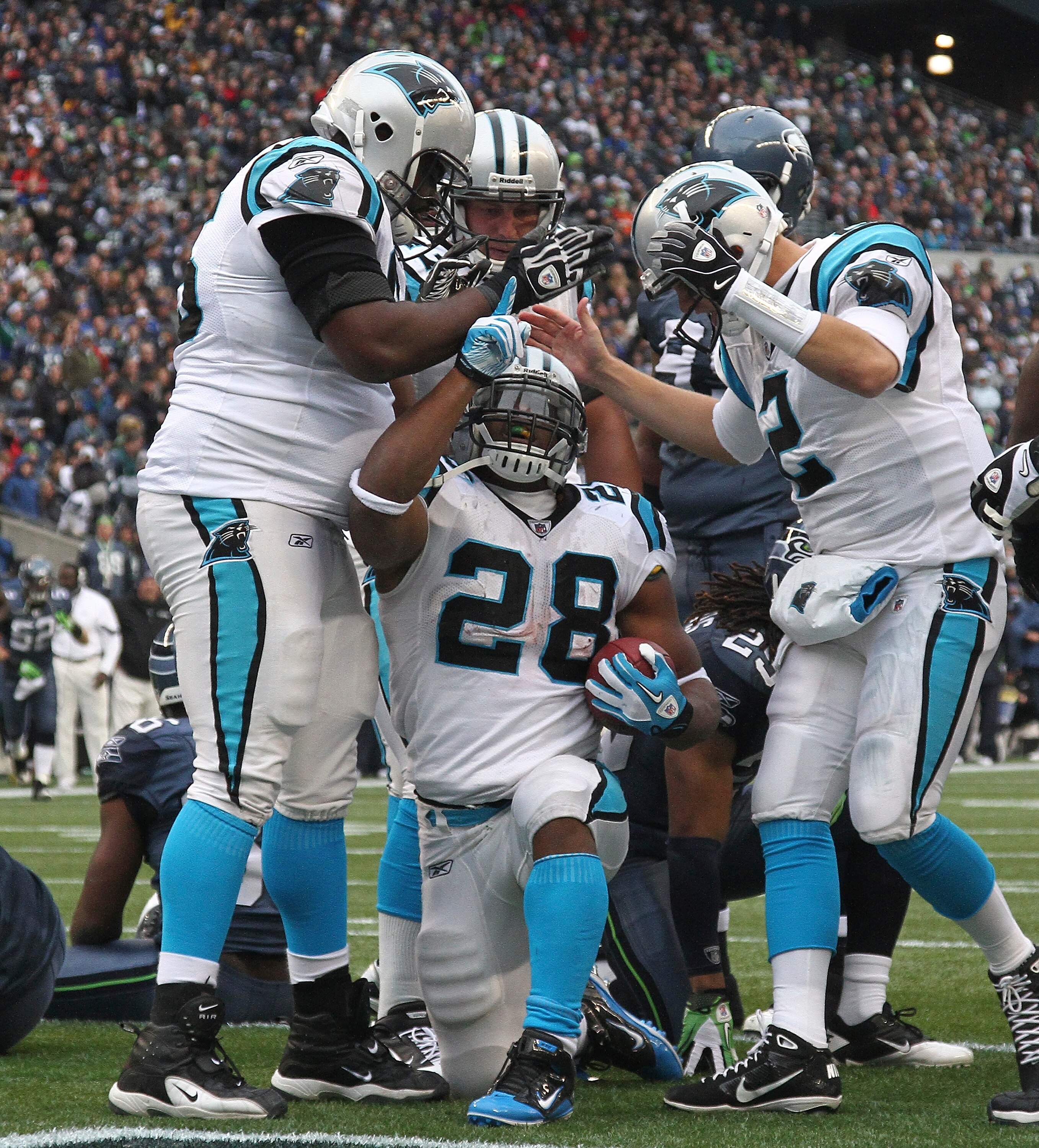 SEATTLE, WA - DECEMBER 05:  Running back Jonathan Stewart #28 of the Carolina Panthers celebrates with teammates after scoring a touchdown in the second quarter against the Seattle Seahawks at Qwest Field on December 5, 2010 in Seattle, Washington. The Se