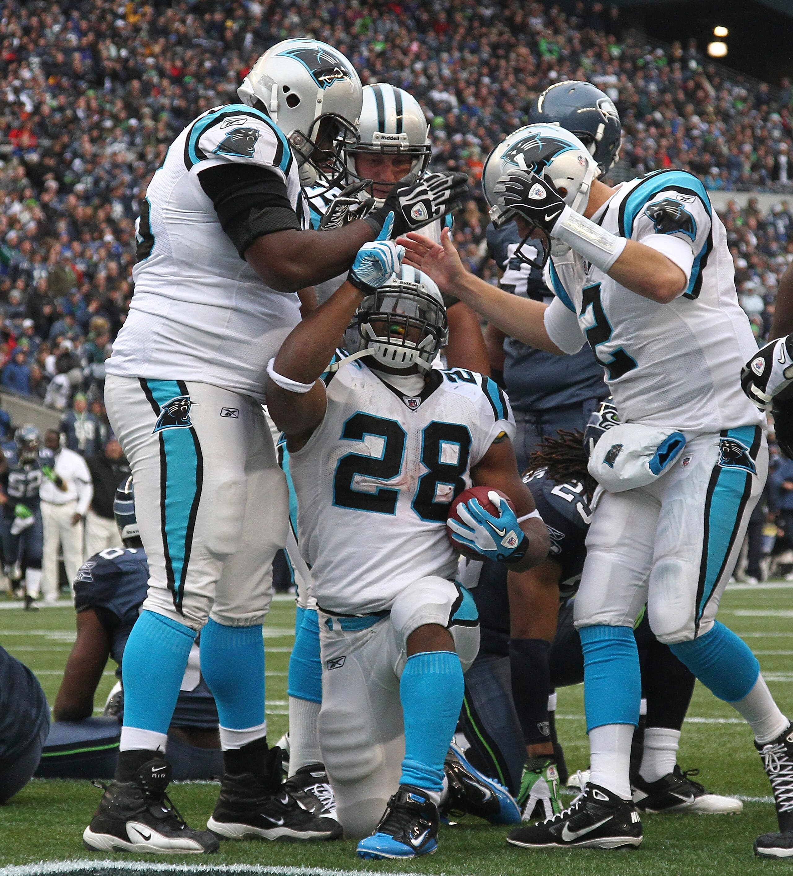 SEATTLE, WA - DECEMBER 05:  Running back Jonathan Stewart #28 of the Carolina Panthers celebrates with teammates after scoring a touchdown in the second quarter against the Seattle Seahawks at Qwest Field on December 5, 2010 in Seattle, Washington. The Se