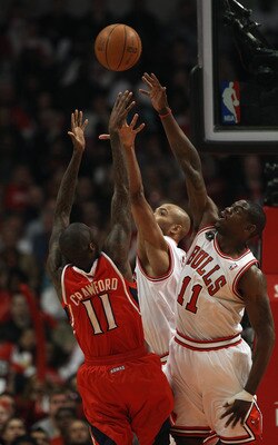 CHICAGO, IL - MAY 04: Jamal Crawford #11 of the Atlanta Hawks puts up a shot under pressure from Ronnie Brewer #11 and Taj Gibson #22 of the Chicago Bulls in Game Two of the Eastern Conference Semifinals in the 2011 NBA Playoffs at the United Center on Ma
