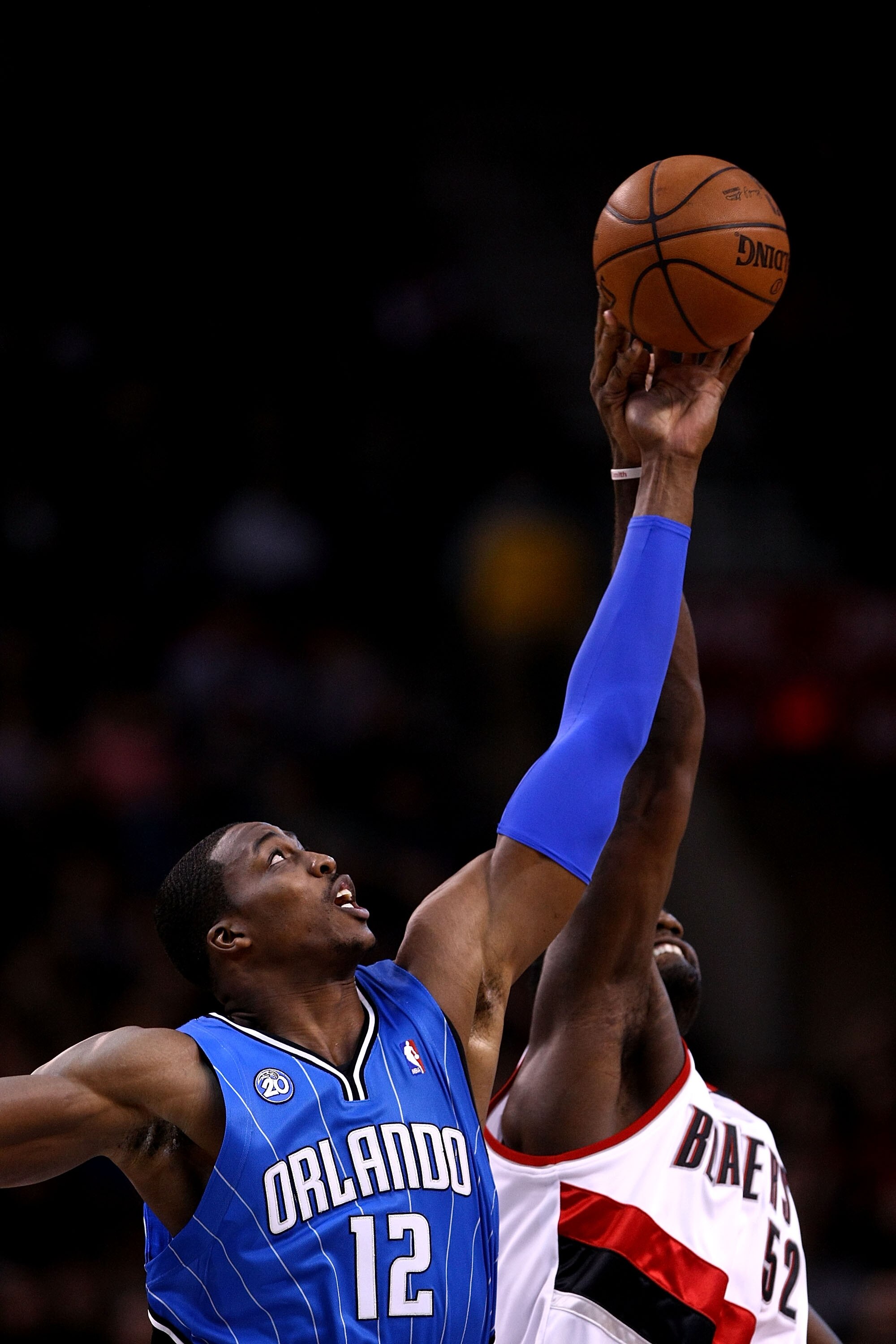 PORTLAND, OR - DECEMBER 09:  Dwight Howard #12 of the Orlando Magic battles Greg Oden #52 of the Portland Trail Blazers forthe opening tip at the Rose Garden on December 9, 2008 in Portland, Oregon.  NOTE TO USER: User expressly acknowledges and agrees th